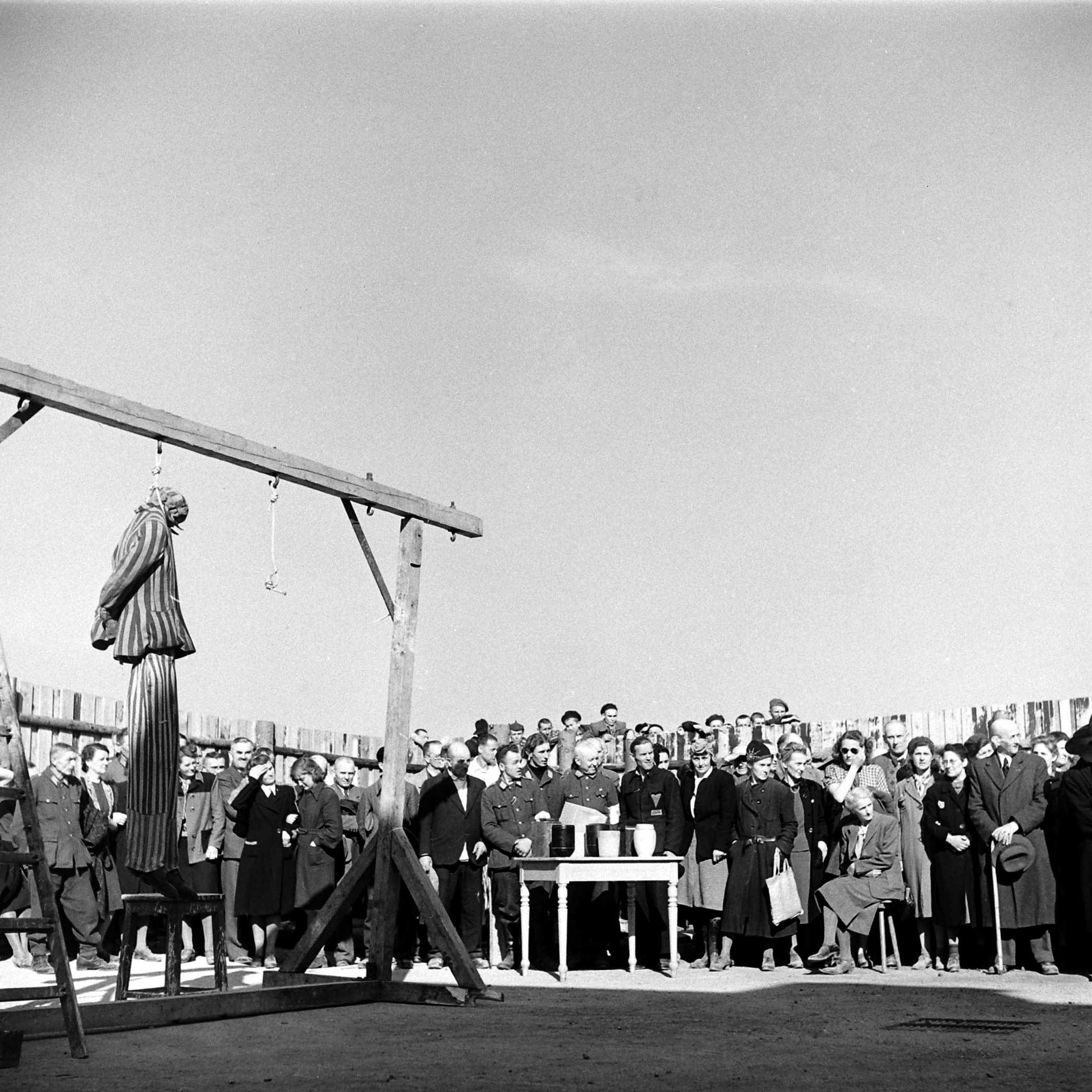Not published in LIFE. As German officers and Weimar civilians bear witness, after Buchenwald's liberation, to atrocities committed at the camp, a dummy in striped prisoner garb hangs from a gallows Ñ a gruesome demonstration of one of the many public ways that inmates were murdered at the camp.