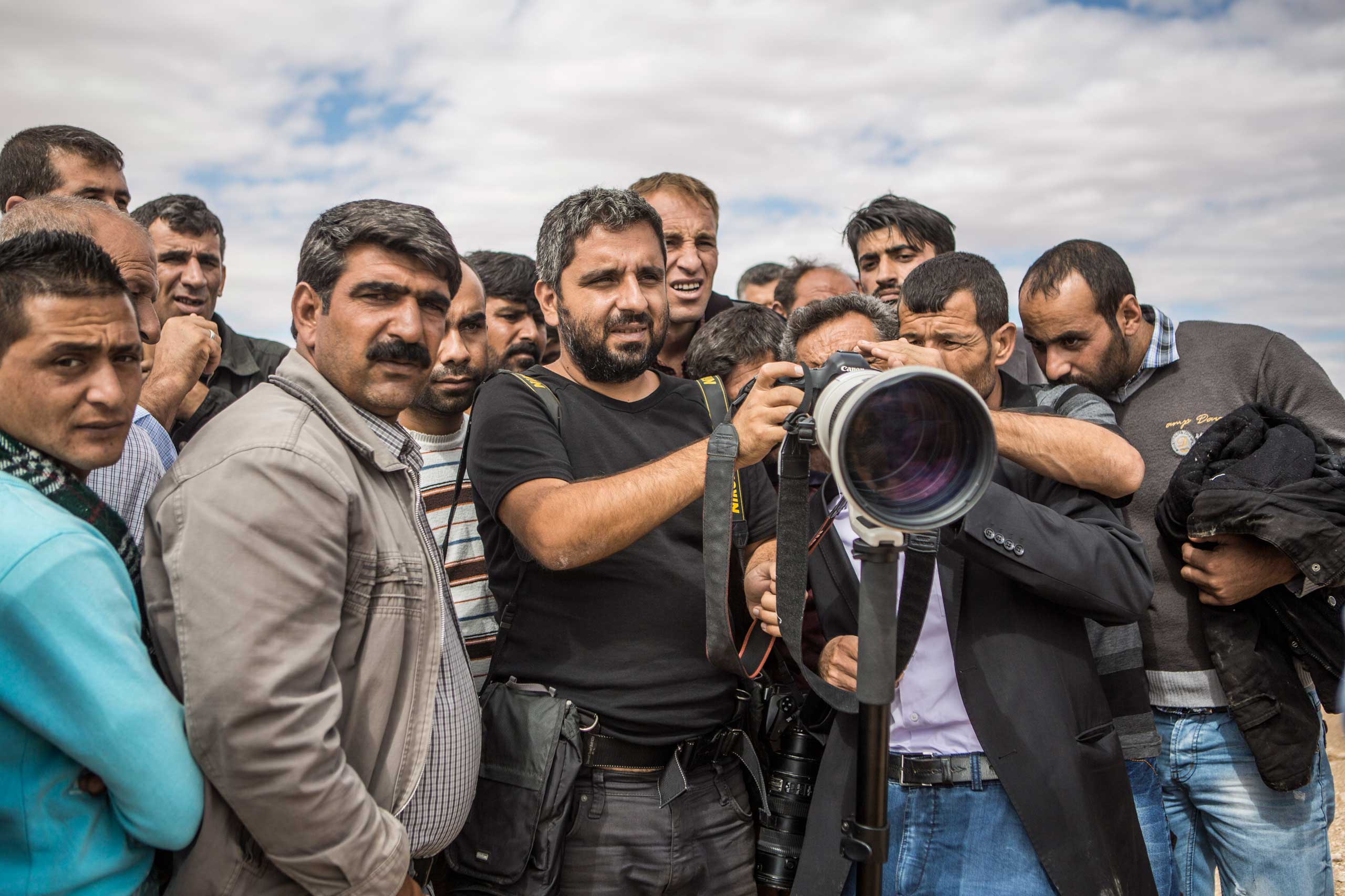 Bulent Kilic (center), TIME's 2014 Wire Photographer of the Year, in Turkey. (Yasin Akgul)