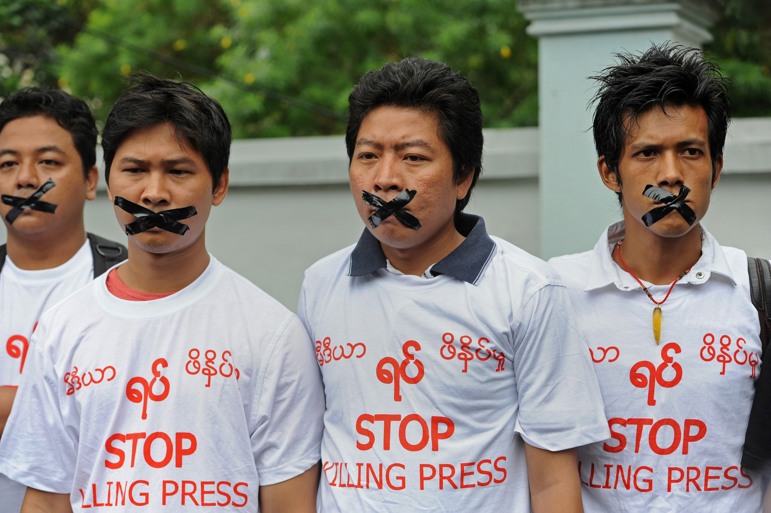 Burmese journalists wear T-shirts that say "Stop Killing Press" during a silent protest for five journalists who were jailed for 10 years on July 10, near the Myanmar Peace Center where Burmese President Thein Sein was scheduled to meet with local artists in Rangoon on July 12, 2014. (Soe Than Win—AFP/Getty Images)