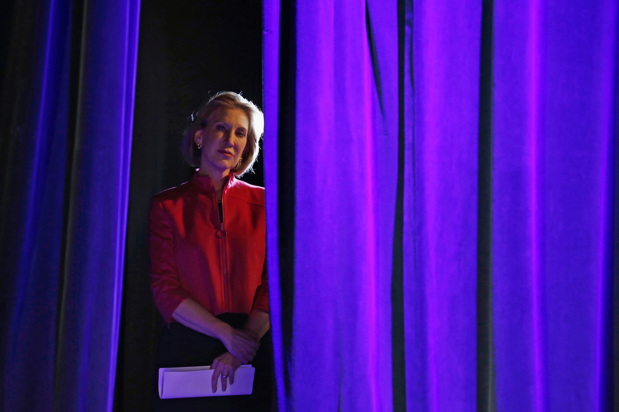 Former Hewlett-Packard Co Chief Executive Officer Carly Fiorina listens to her introduction from the side of the stage at the Freedom Summit in Des Moines, Iowa on Jan. 24, 2015.