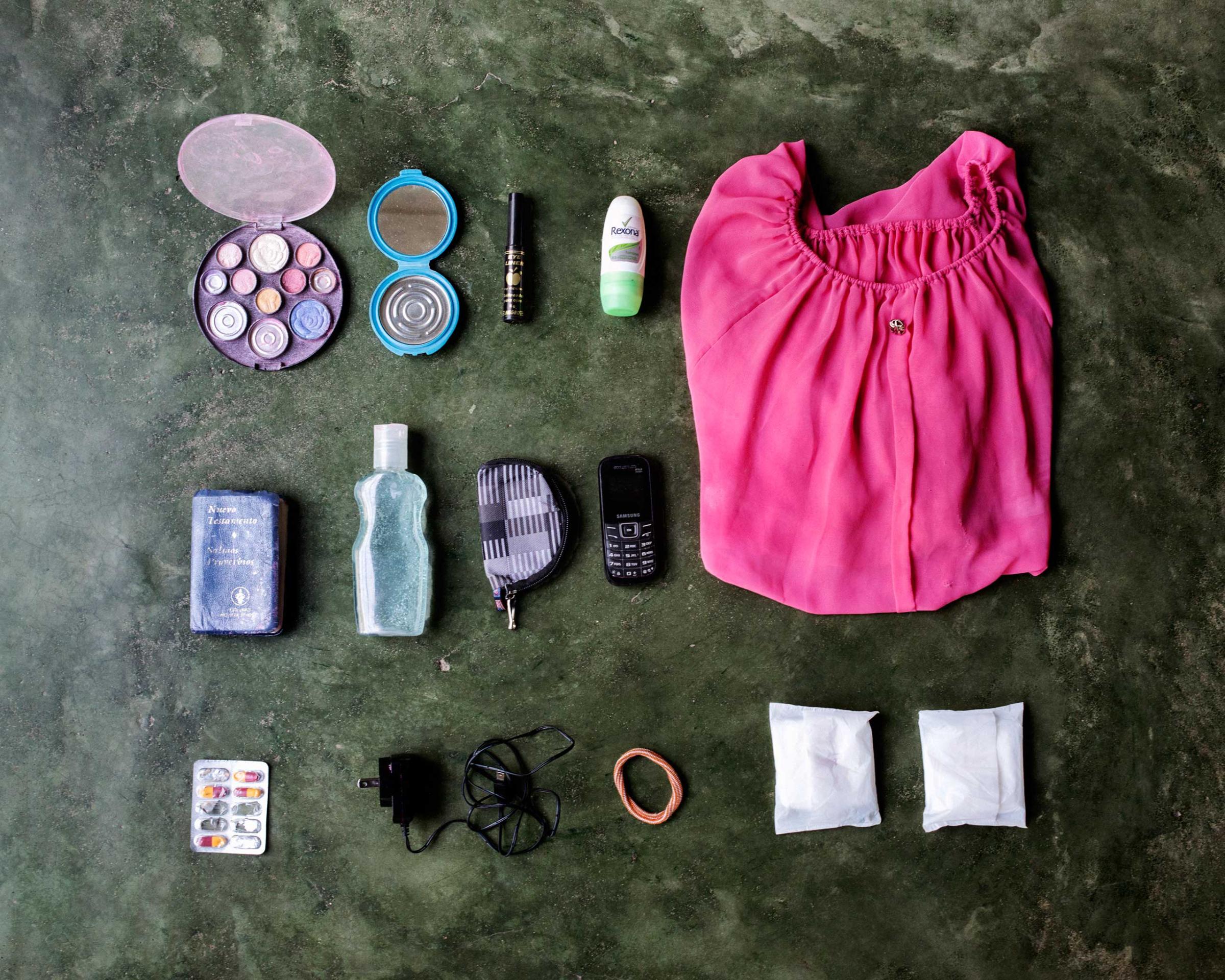 Delmis Helgar, 32, from Honduras. She is in a hurry to reach Houston where her little daughter is living with some relatives, after her ex-husband was recently deported. In her bag has a make-up set, hand mirror, lip gloss, deodorant, shirt, small bible, face gel, wallet, mobile phone, pills, battery charger, hair band and two tampons.