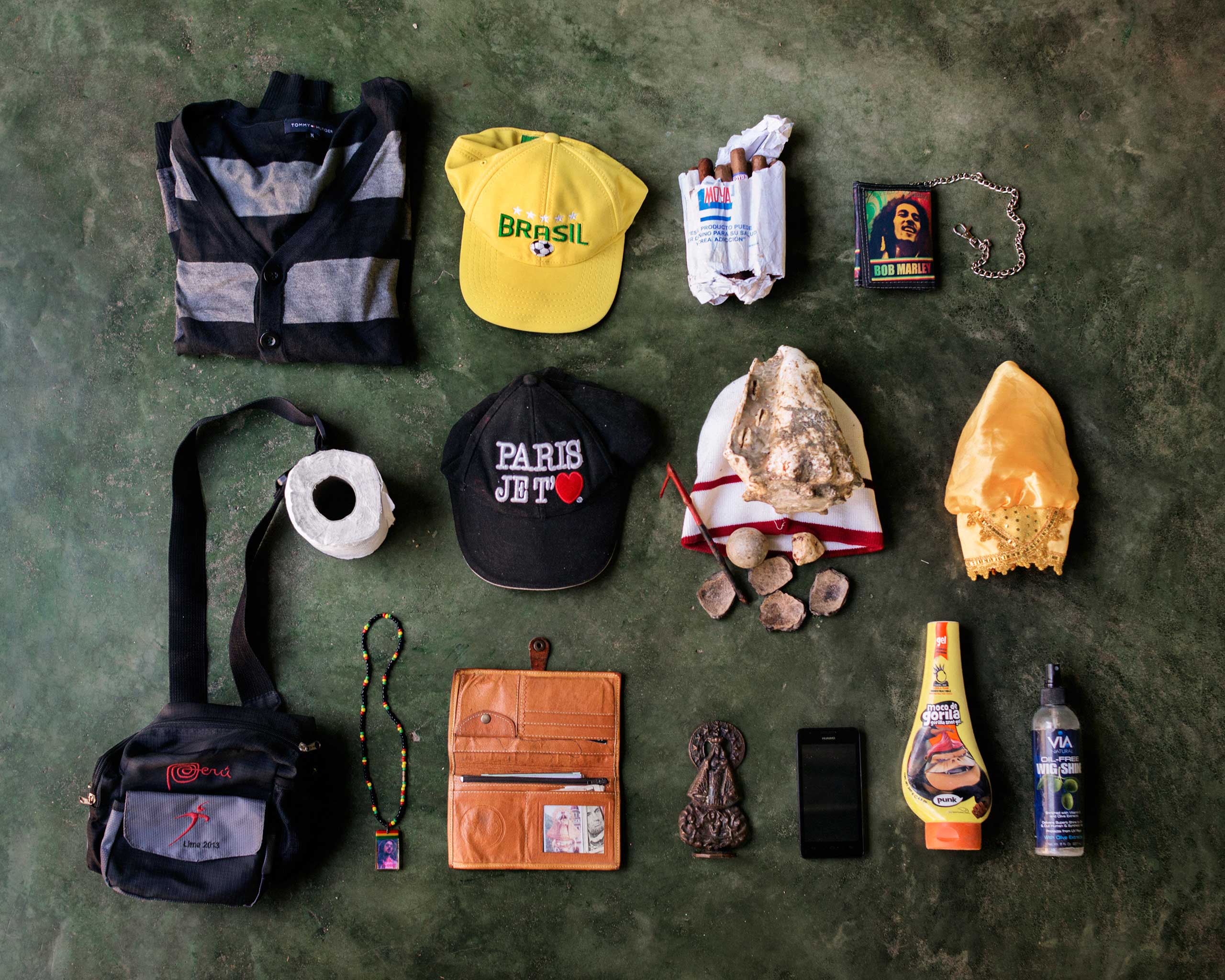 Roger Savòn Court, 40, from Cuba. He flew to Colombia and traveled illegally through South America up to Guatemala. He wants to reach the U.S. and work honestly in America. In his bag, he has a sweater, two caps, cigars, a wallet, toilet paper, a big shell talisman to guide him on the journey, a headdress, a fanny pack, a necklace, a document holder, a small Virgin Mary statue, a cell phone, hair gel and a detergent oil for the skin.