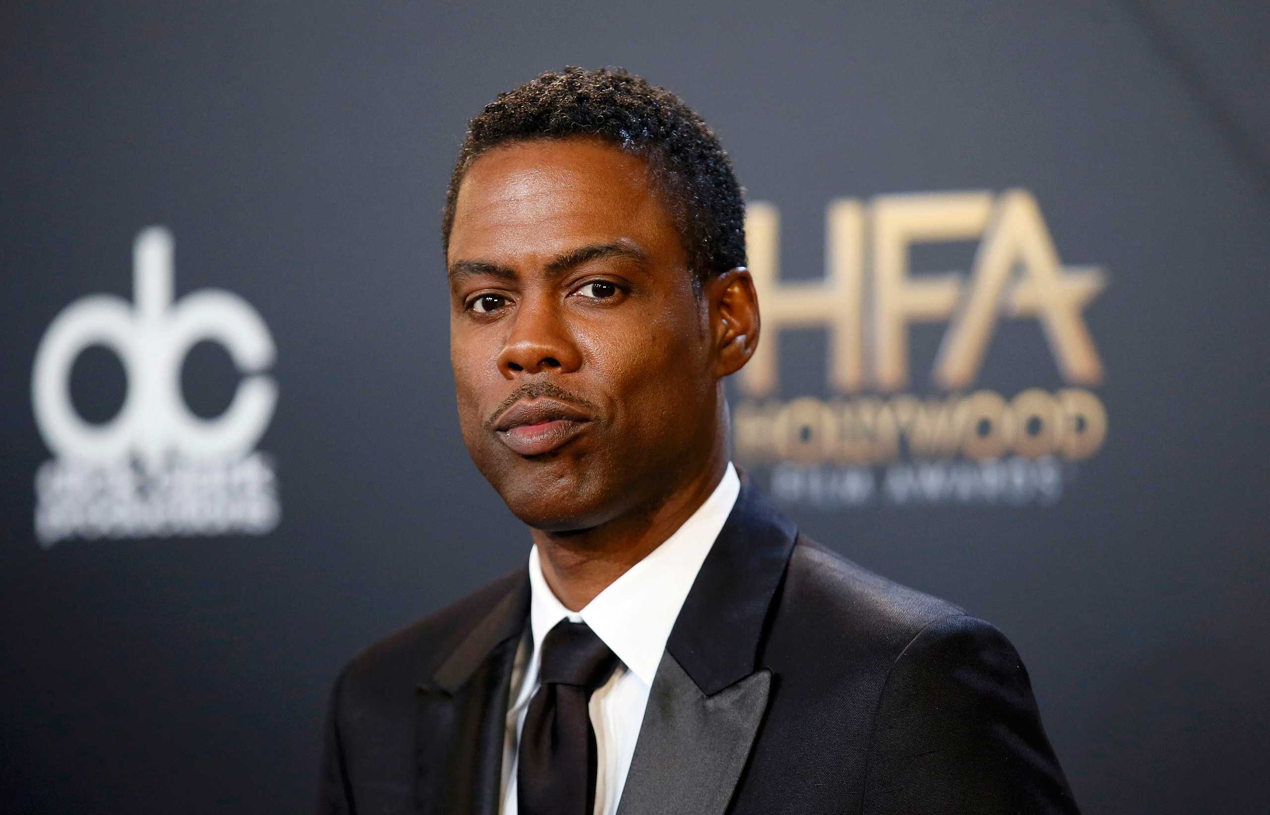 Chris Rock poses with his award during the Hollywood Film Awards in Hollywood