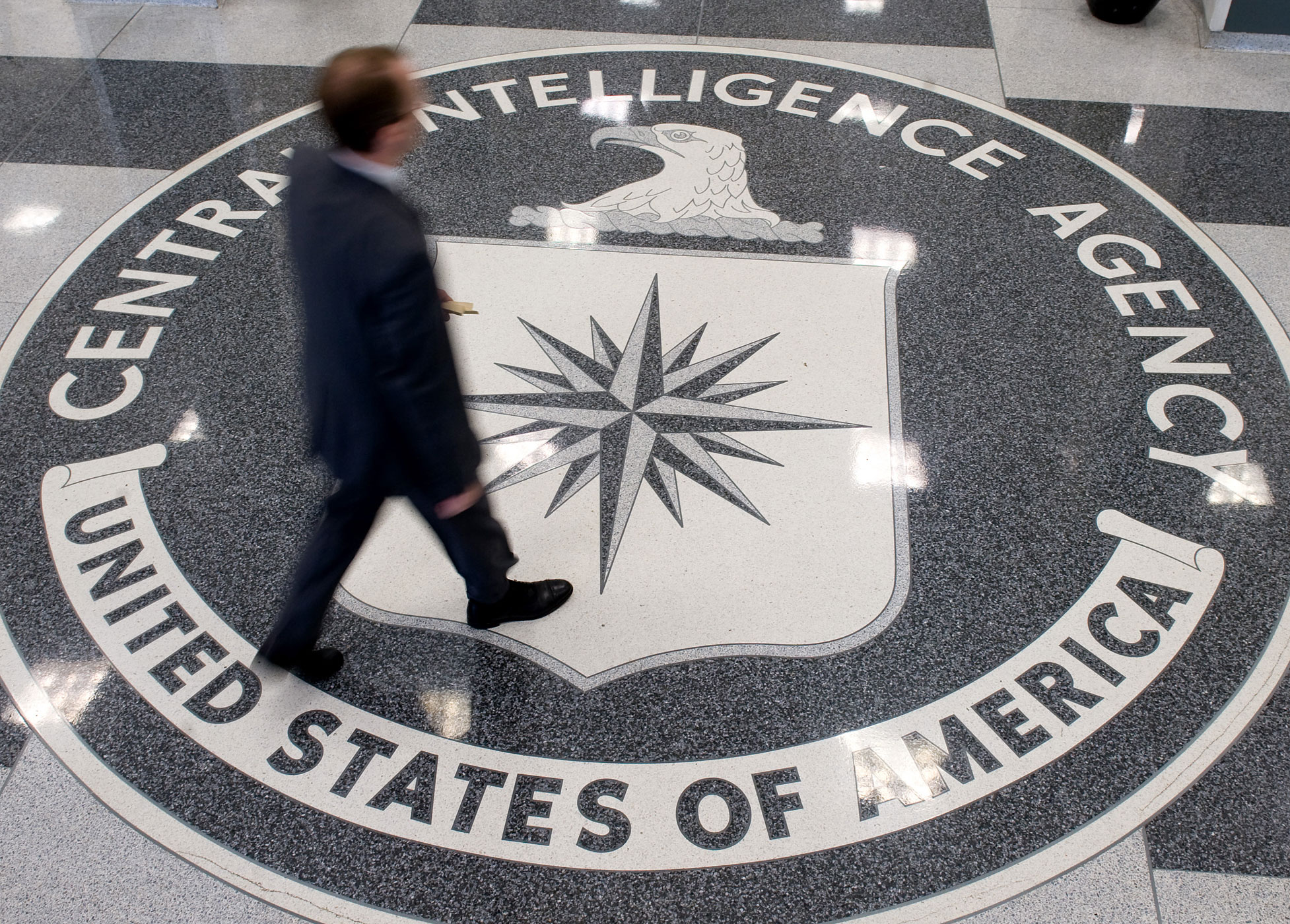 A man crosses the Central Intelligence Agency (CIA) logo in the lobby of CIA Headquarters in Langley, Virginia, on August 14, 2008. (Saul Loeb—AFP/Getty Images)