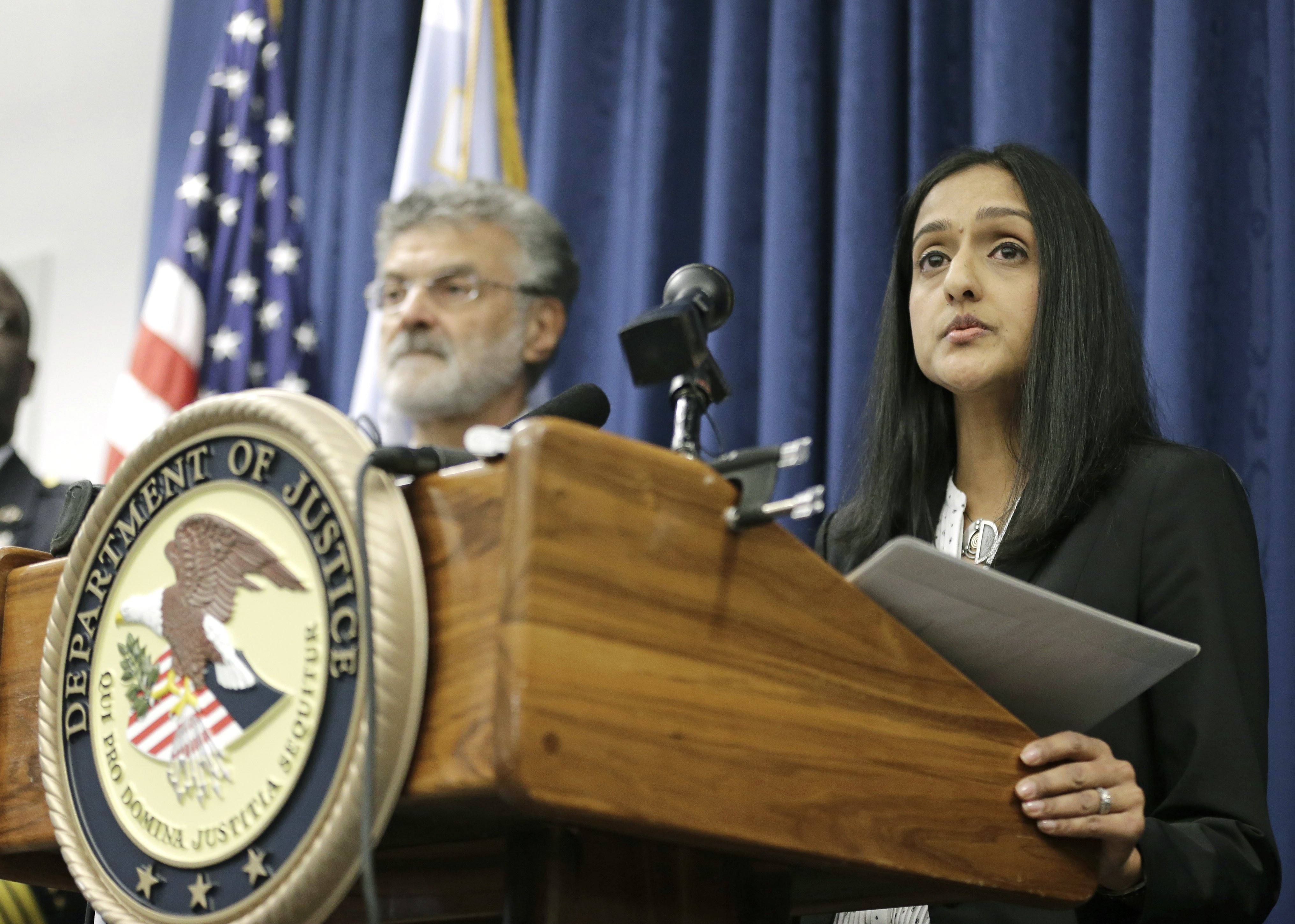 U.S. Acting Assistant Attorney General Vanita Gupta for the Civil Rights Division, right, makes a statement during a news conference on Dec. 4, 2014, in Cleveland. (Tony Dejak—AP)
