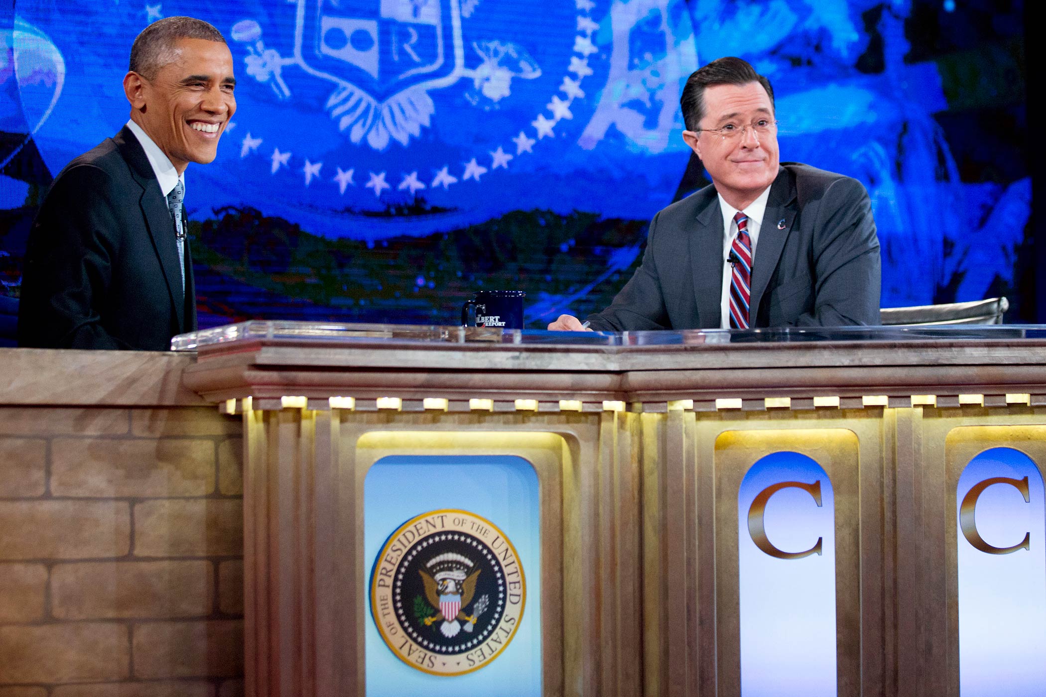 President Barack Obama talks to Stephen Colbert during a taping of <i>The Colbert Report</i> in Lisner Auditorium at George Washington University on Dec. 8, 2014 in Washington, DC. (Andrew Harrer—Getty Images)