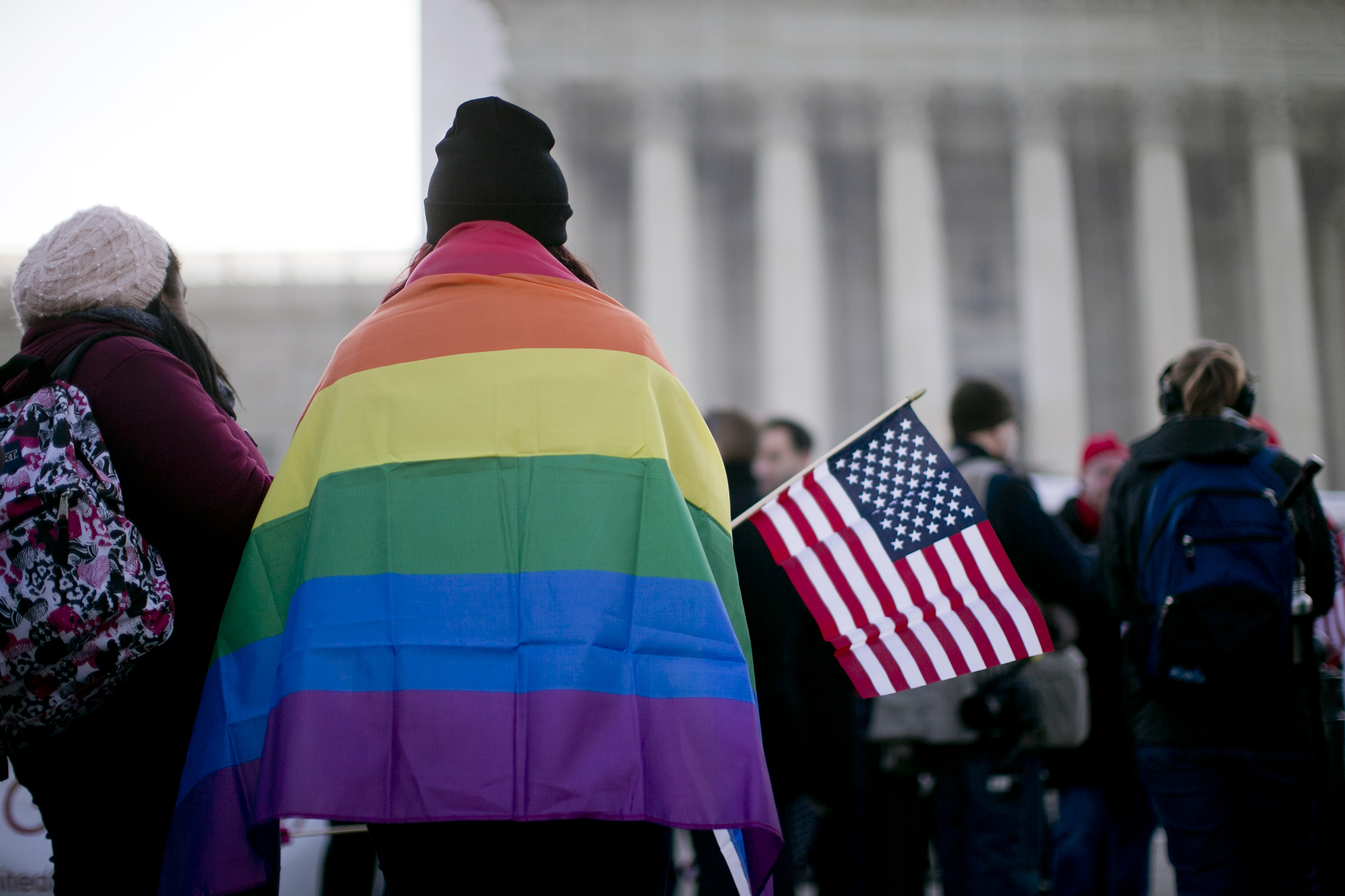 A supporter of same-sex marriage wears a rainbow flag in front of the U.S. Supreme Court in Washington, D.C., U.S., on  March 26, 2013. (Bloomberg via Getty Images)