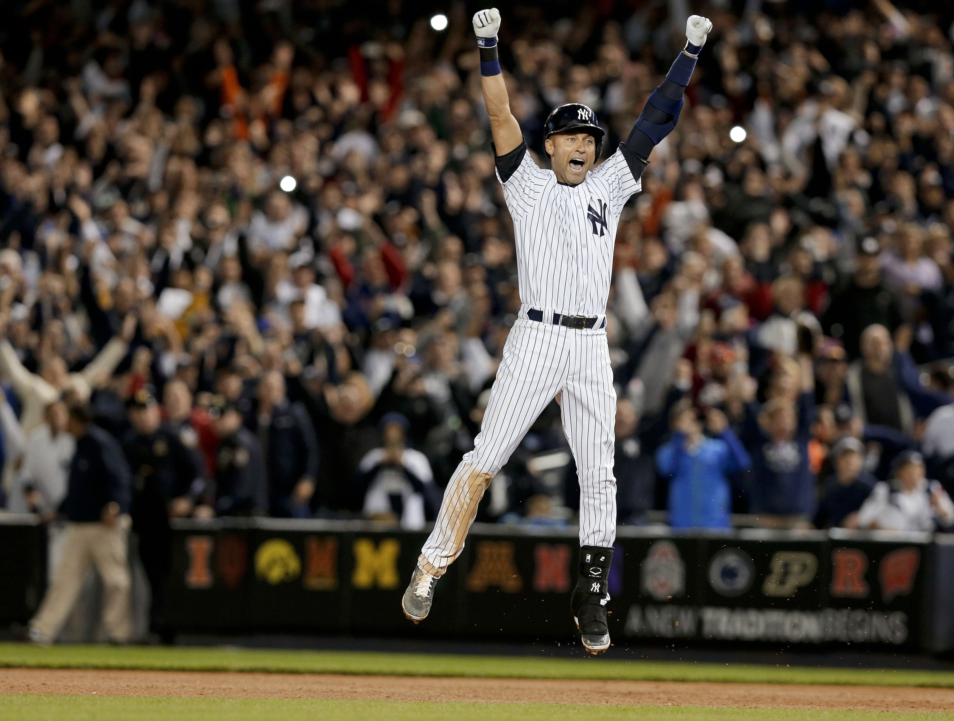 New York Yankee Derek Jeter jumps after hitting the game-winning single against the Baltimore Orioles in the ninth inning of a baseball game on Sept. 25, 2014, in New York.