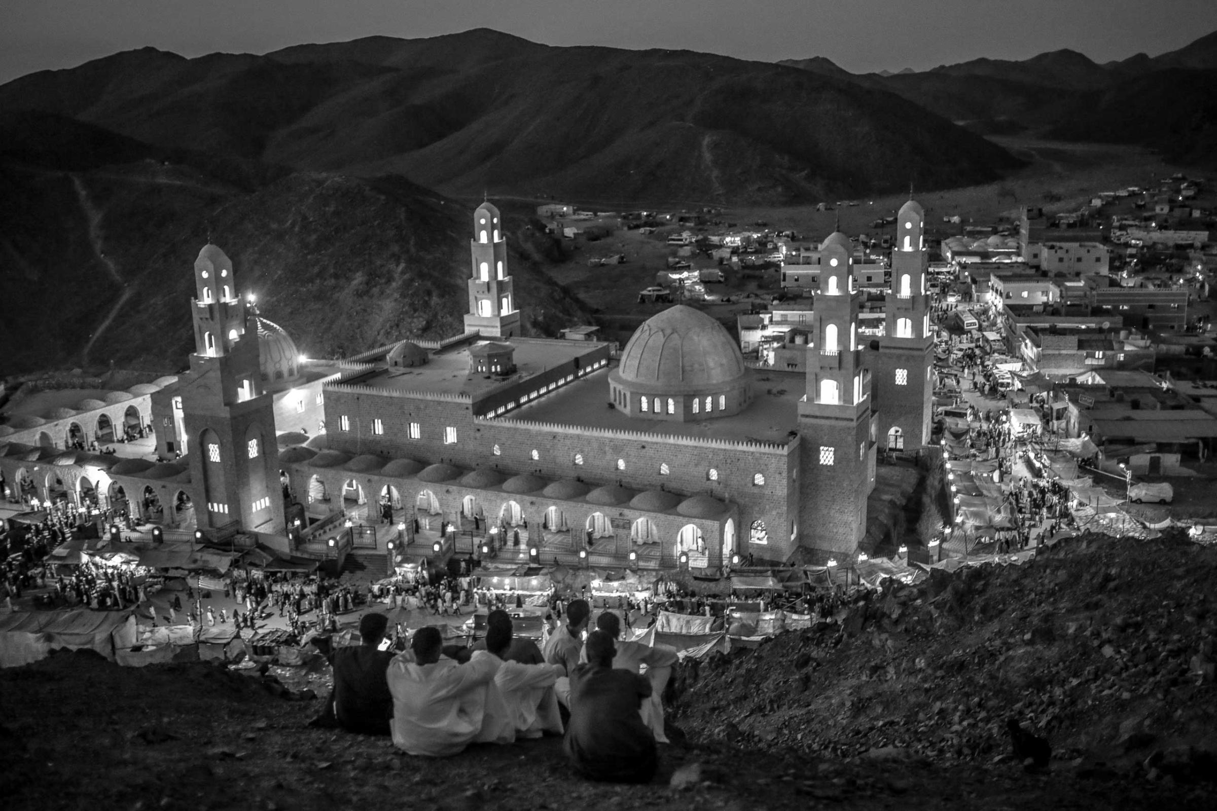 Sufi Muslims, mostly from upper Egypt, look onto the mosque of Abu-Alhassan Al-Shazly, one of the most influential Sufi scholar, during the annual celebration of his birth. El-Shazily's mosque is located in Humaythara, a remote valley and town in Egypt's Red Sea desert. Sept, 30, 2014.
