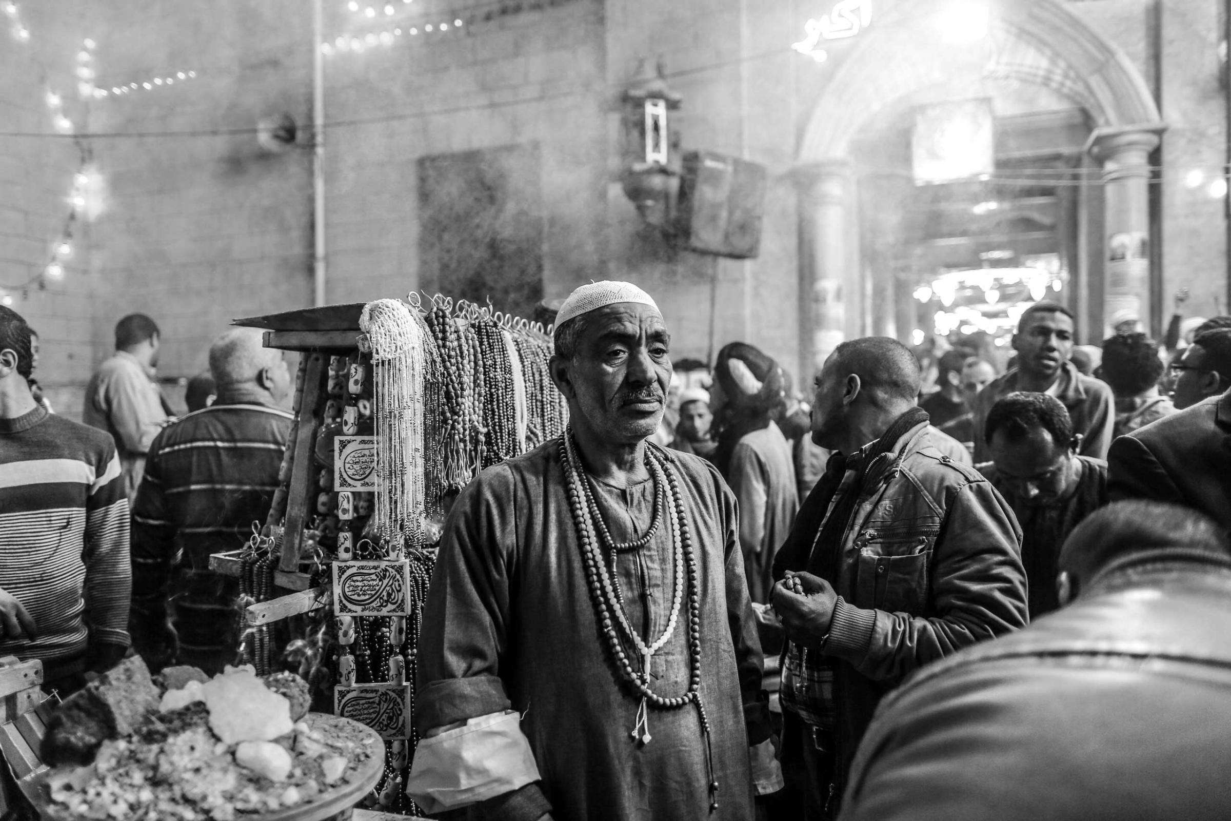 A merchant stands the mosque of Al-Hussein, the grand son of the prophet, in downtown Cairo. Feb. 25, 2014.