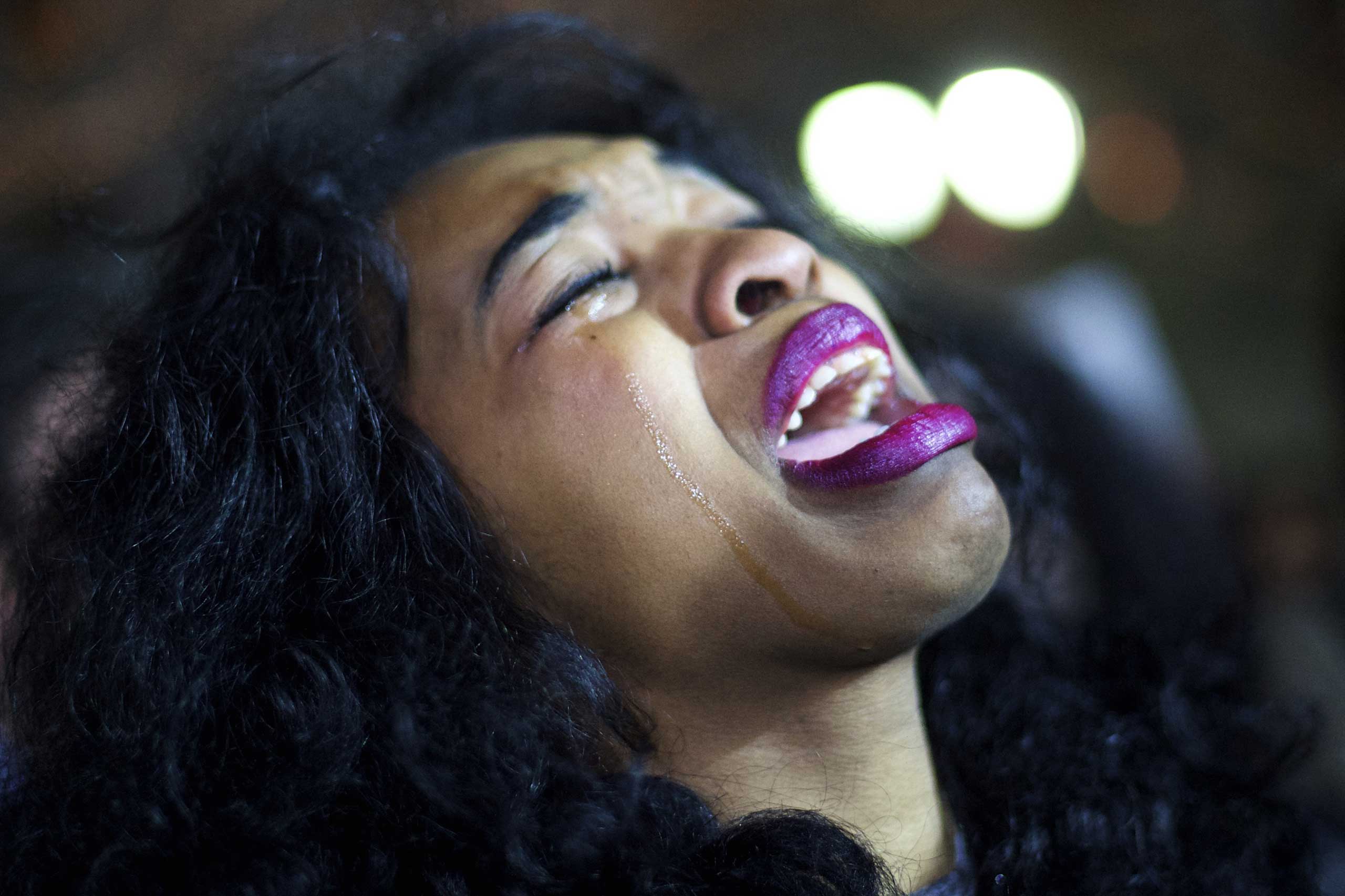 A demonstrator cries while gathering to protest the Eric Garner grand jury decision during a Christmas Tree lighting ceremony at City Hall in Philadelphia on Dec. 3, 2014.