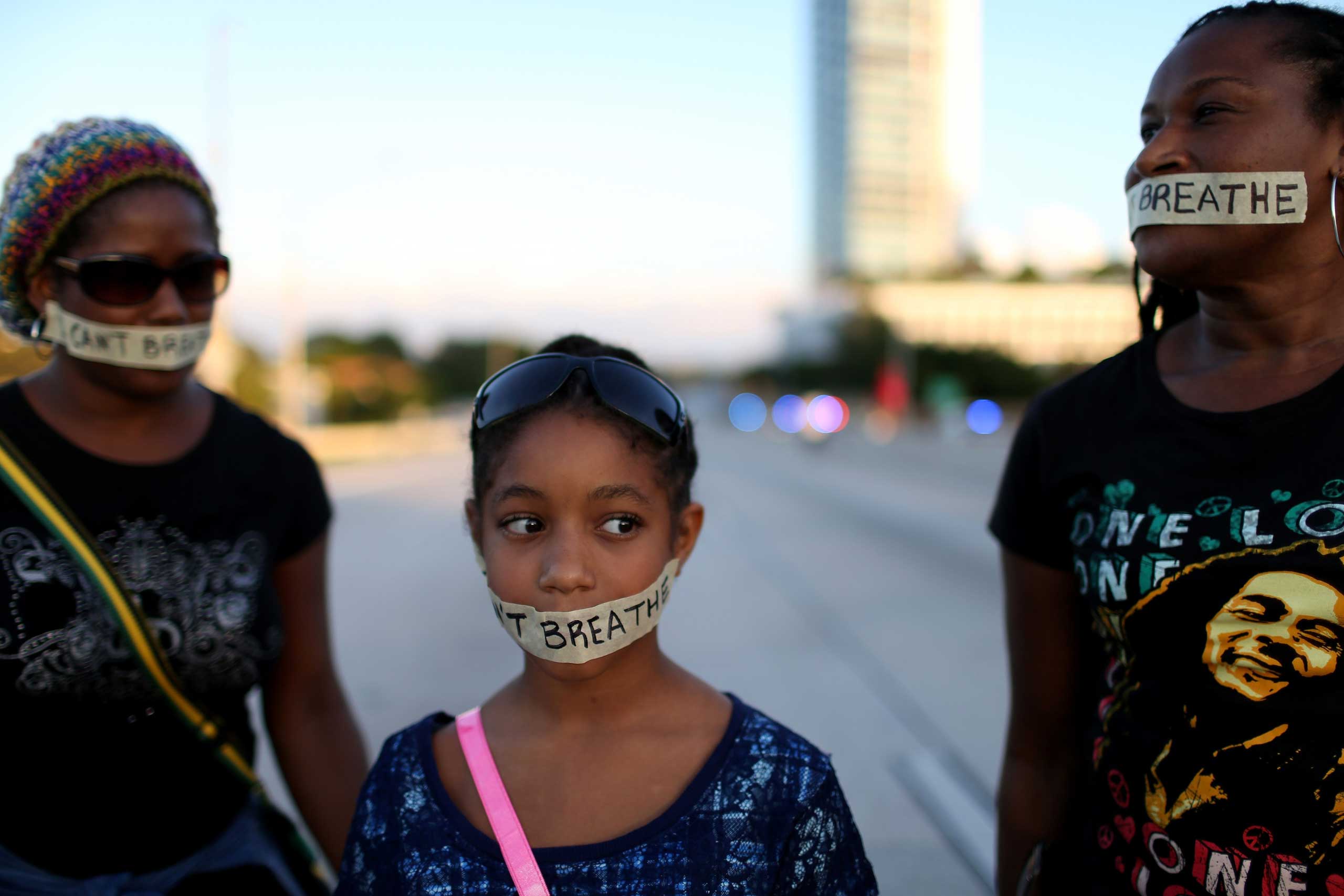 Demonstrators stand with tape reading, " I Can't Breathe", as they march along Interstate 195 after police shut the road down on Dec. 7, 2014 in Miami. (Joe Raedle—Getty Images)