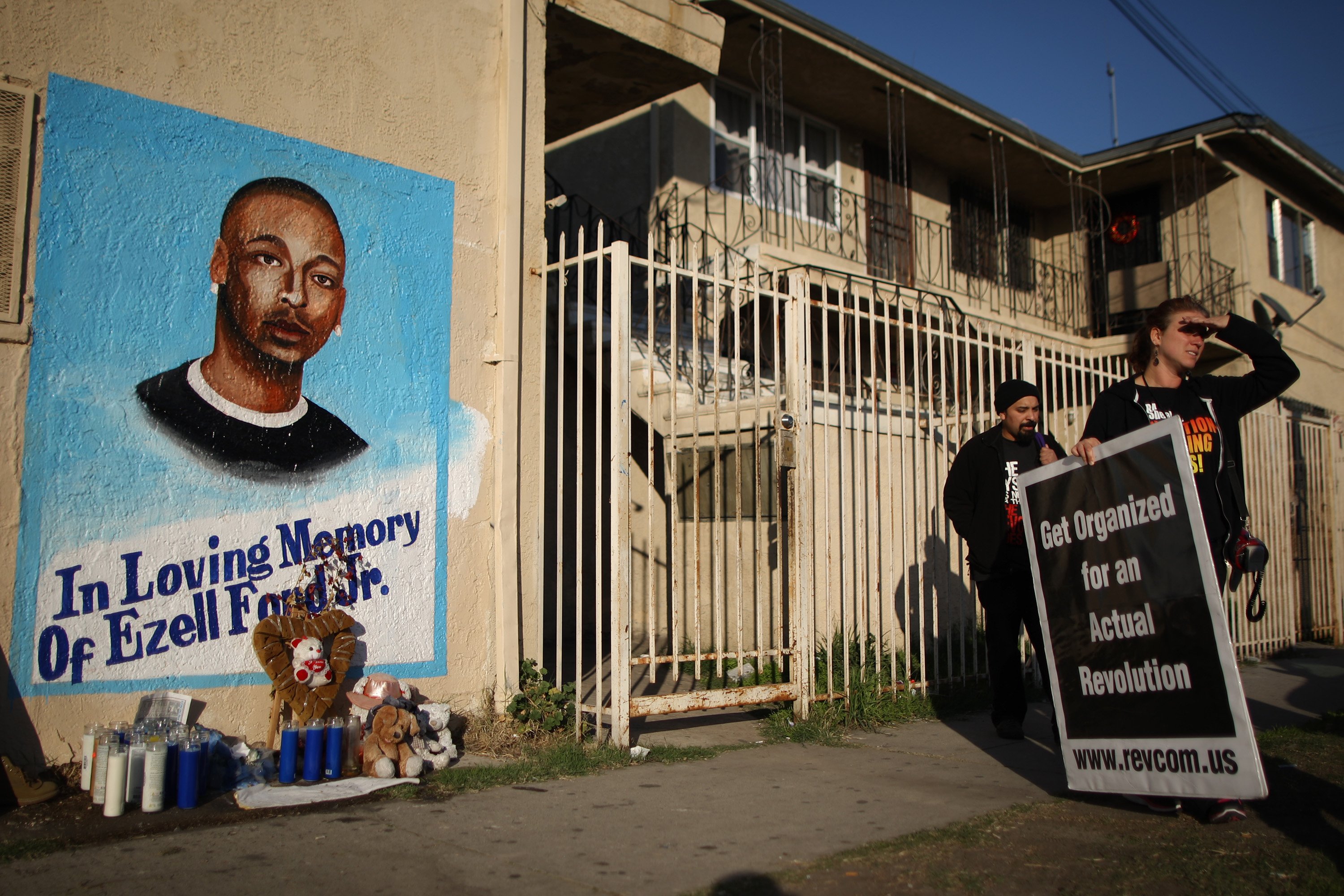 Activists look at a mural of Ezell Ford, a 25-year-old mentally ill black man at the site where he was shot and killed by two LAPD officers in August on Dec. 29, 2014 in Los Angeles. (David McNew—Getty Images)