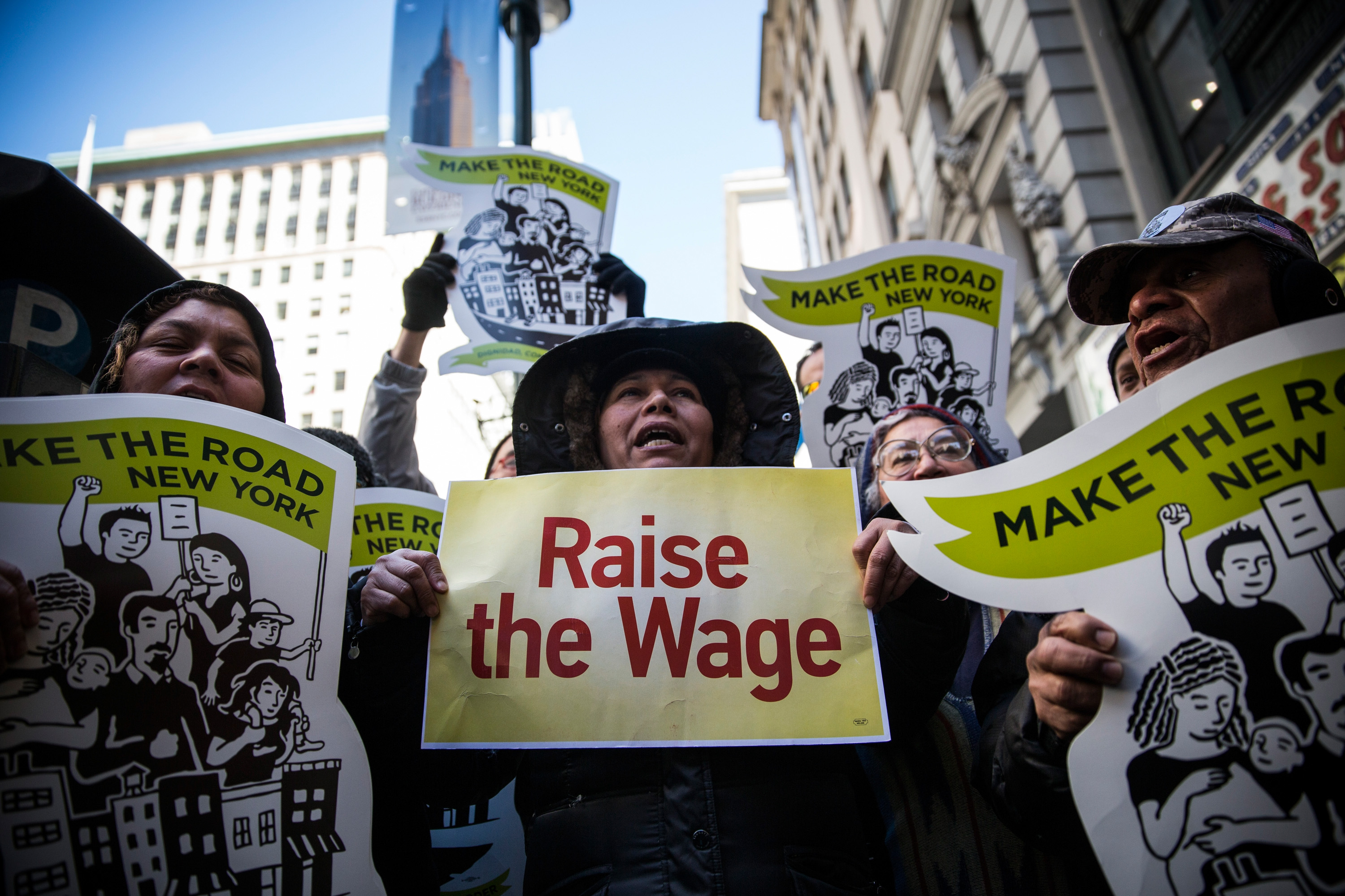 Women hold banners during a protest for higher wages for fast food workers on March 18, 2014 in New York City. (Andrew Burton--Getty Images)