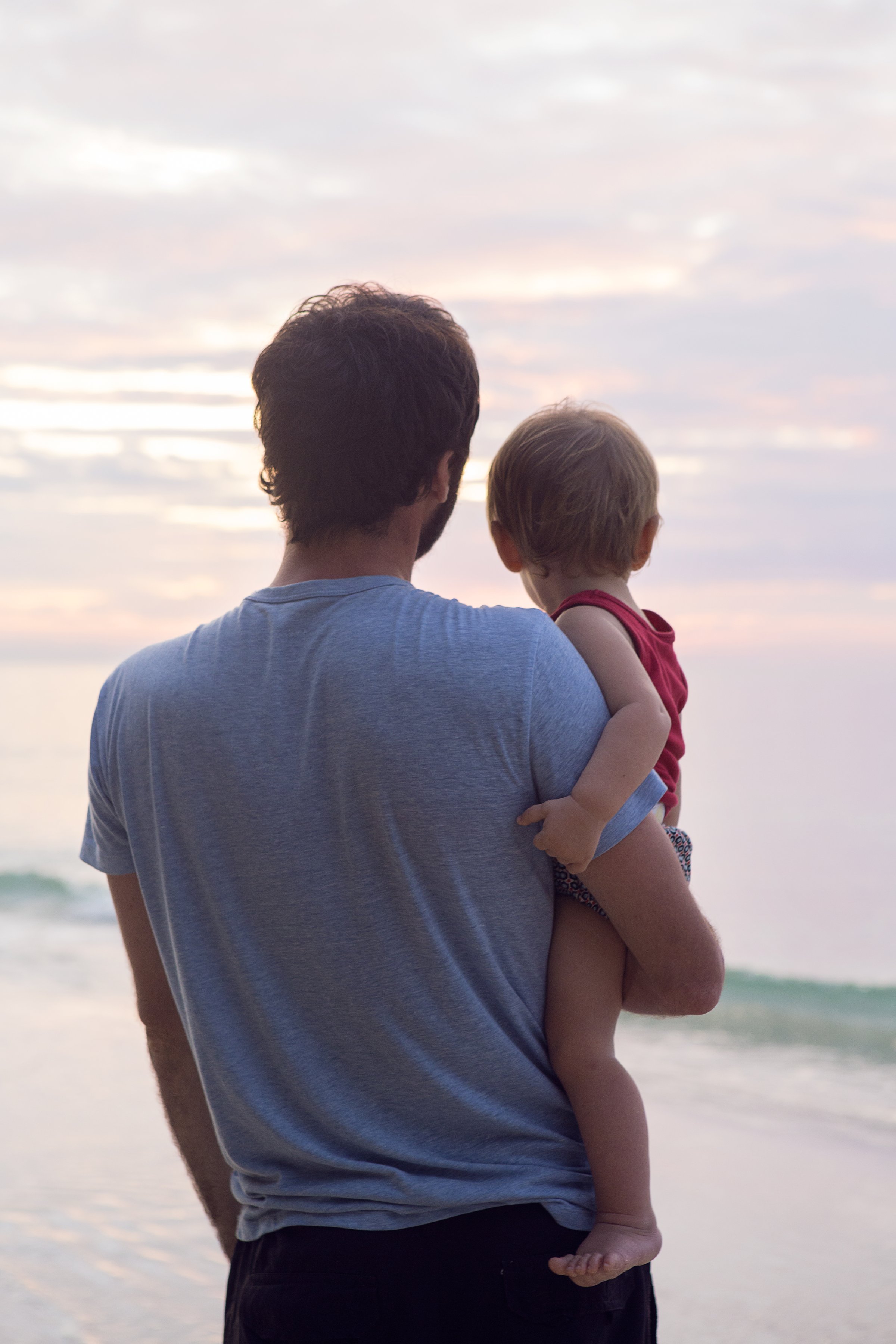 father-holding-baby-beach