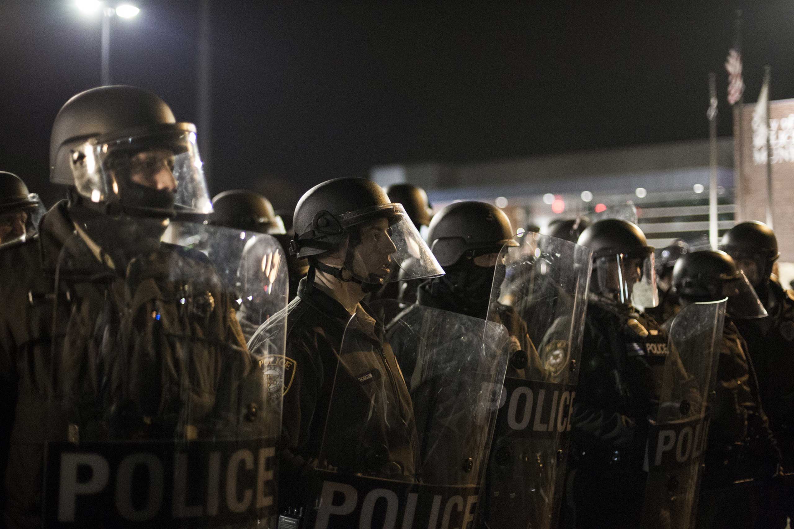 Police in riot gear stand in line opposing protesters in Ferguson, Mo. on Nov. 28, 2014. (Jim Vondruska—Xinhua Press/Corbis)