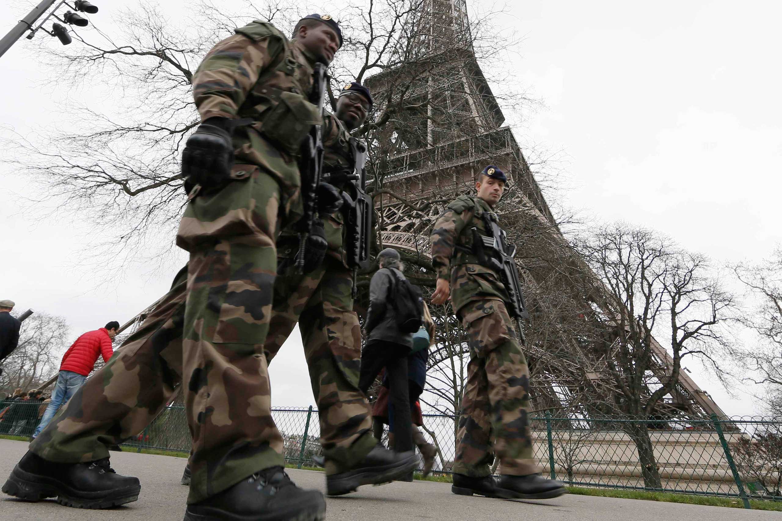 French soldiers patrol near the Eiffel Tower in Paris as part of the "Vigipirate" security plan on Dec. 23, 2014. (Gonzalo Fuentes—Reuters)