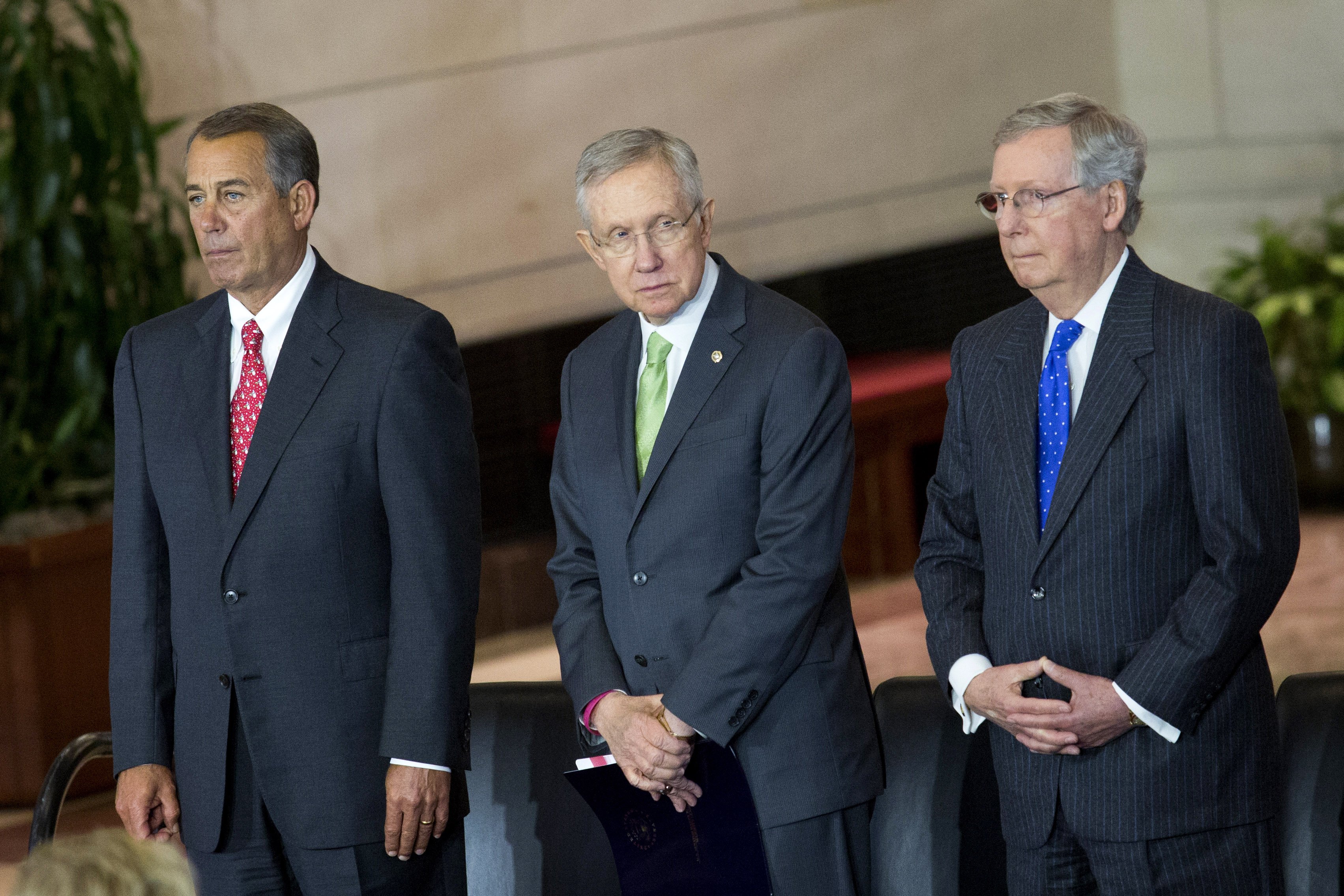 From Left: Speaker of the House John Boehner, Senate Majority Leader Harry Reid and Senate Minority Leader Mitch McConnell gather onstage prior to the start of a Congressional Gold Medal Ceremony for World War II era Civil Air Patrol members on Dec. 10, 2014 in Washington D.C. (Drew Angerer—Getty Images)