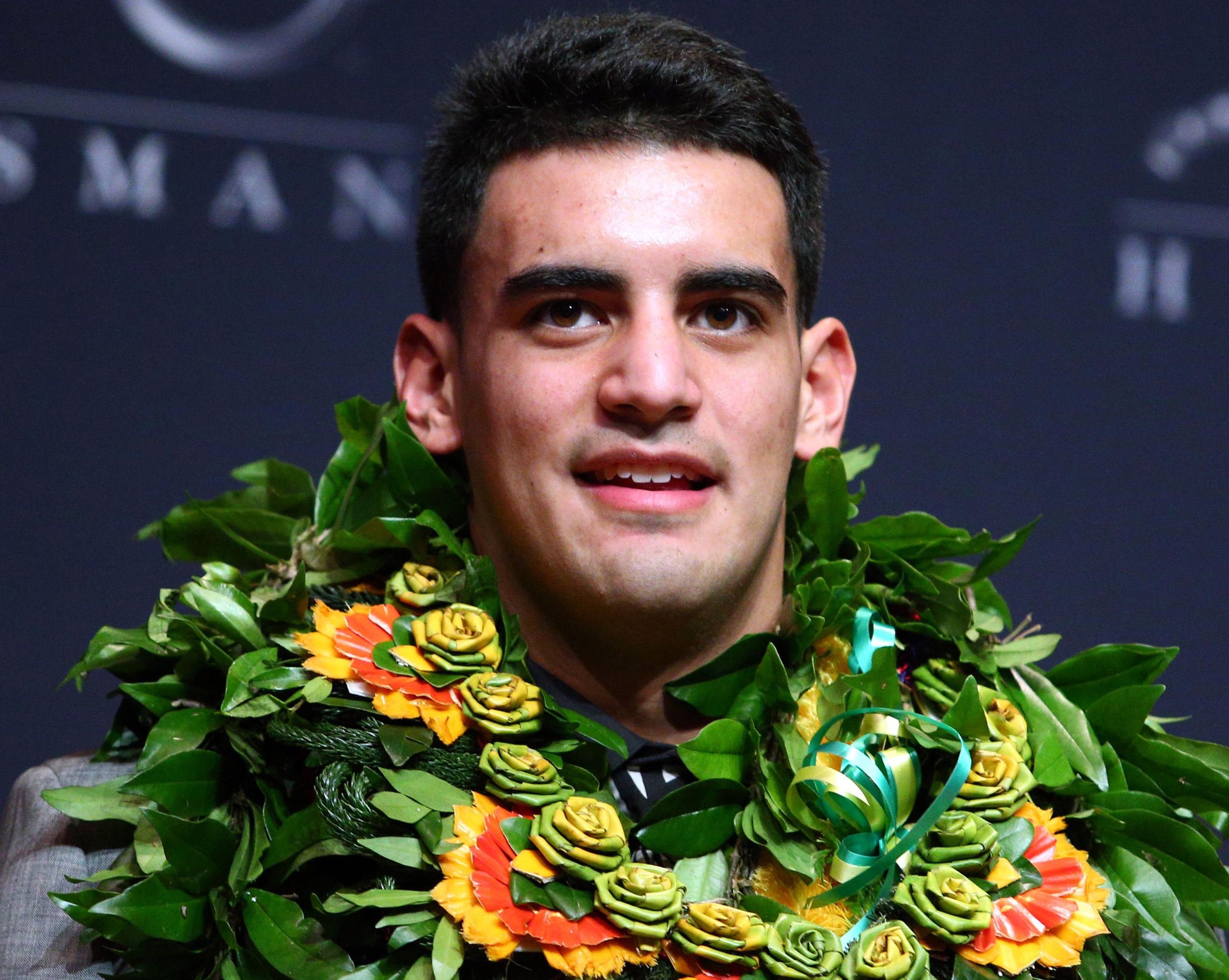 Oregon Ducks quarterback Marcus Mariota answers questions during a press conference after winning the Heisman Trophy