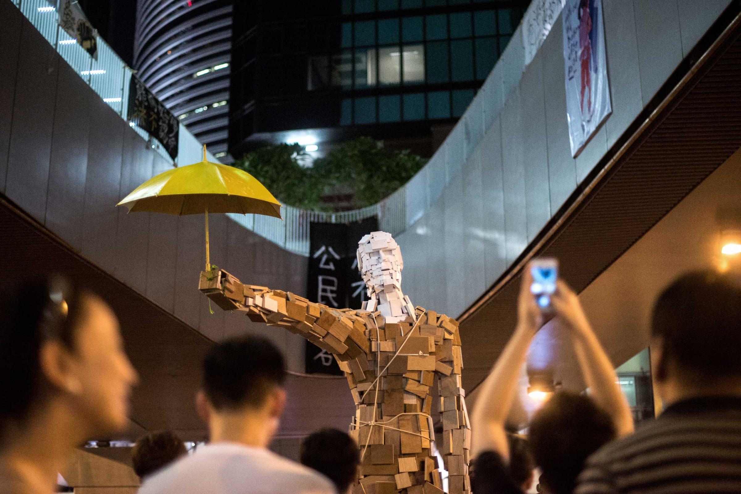 The statue "Umbrella Man" by the Hong Kong artist known as Milk, is set up at a pro-democracy protest site next to the central government offices in Hong Kong on Oct. 5, 2014.