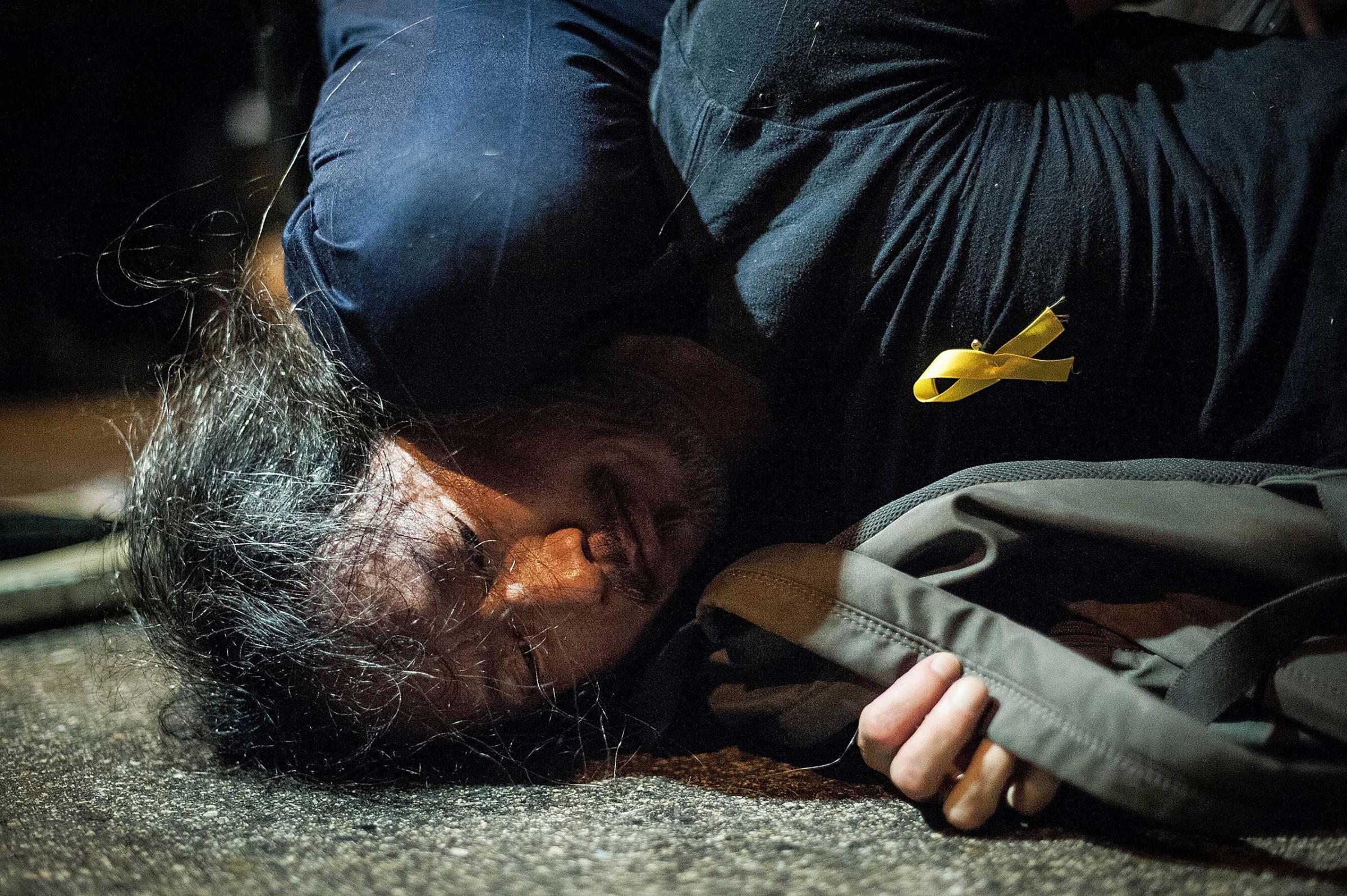 Police arrest a pro-democracy protester on Lung Wo Road outside Hong Kong's Government complex on Nov. 30, 2014 in Hong Kong.