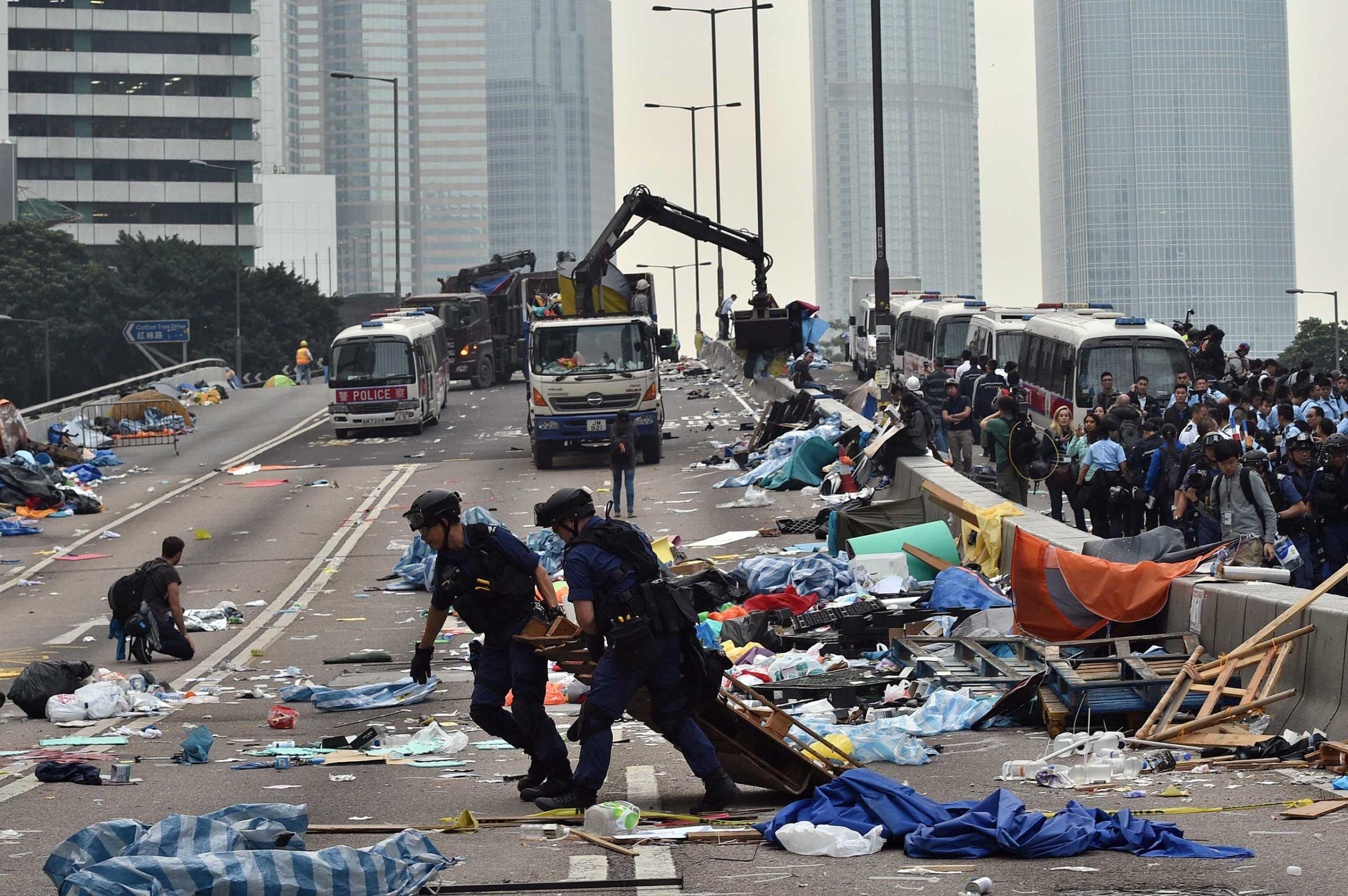 Hong Kong police dismantle the remains of the pro-democracy protest camp in the Admiralty district of Hong Kong on Dec. 11, 2014.