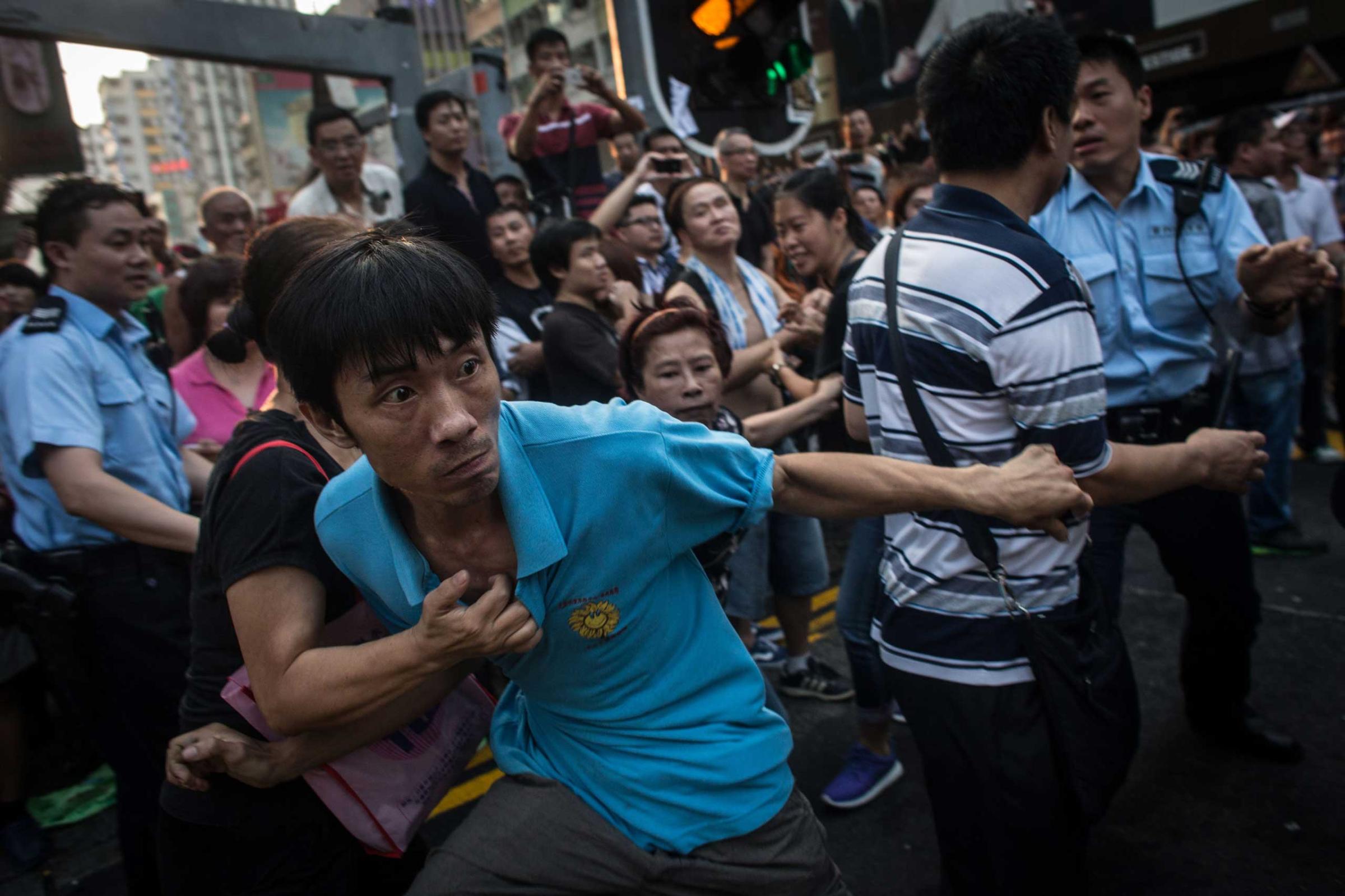 A local resident breaks through police lines and attempts to reach the pro-democracy tent on Oct. 3, 2014 in Mong Kok, Hong Kong.
