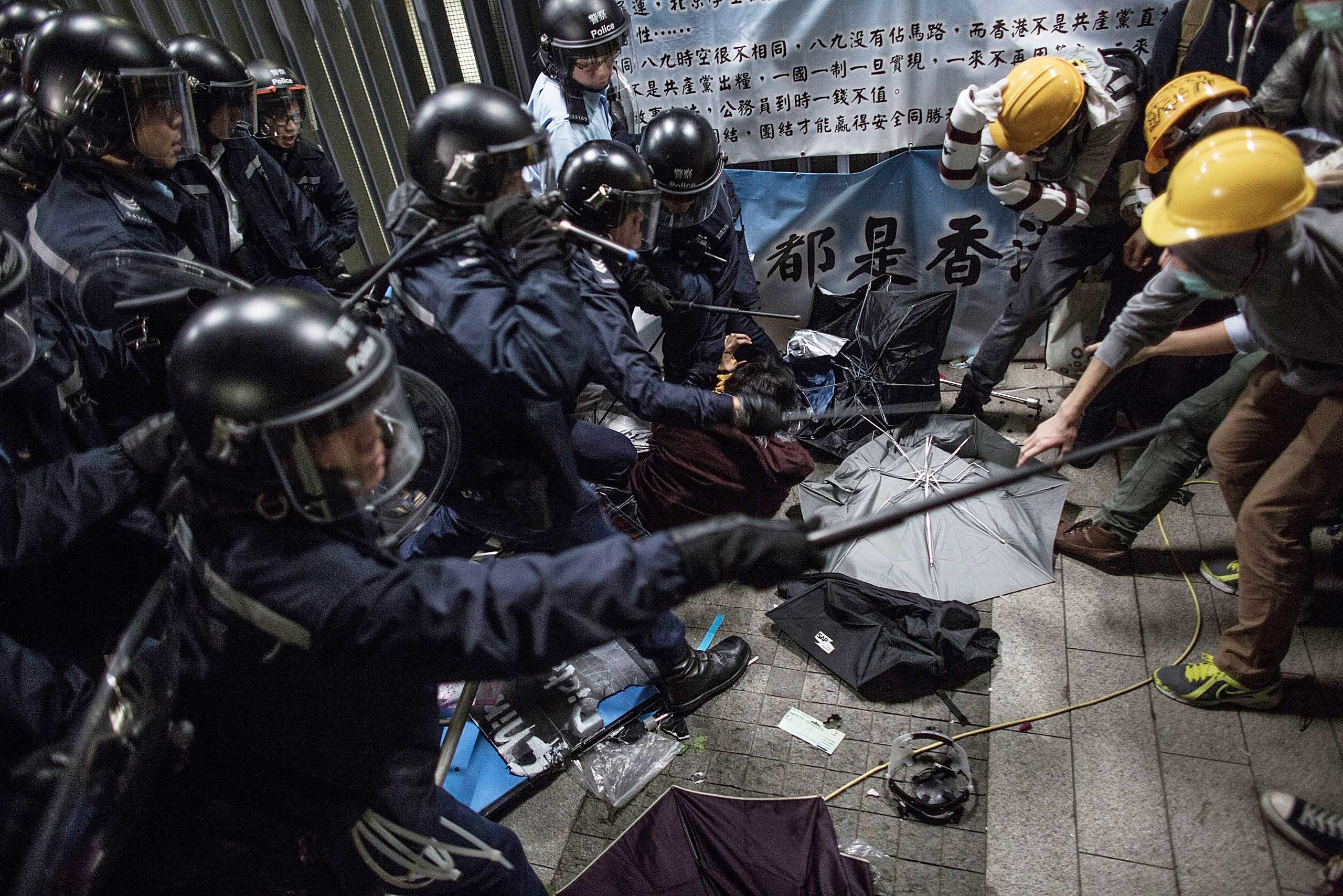 Police officers disperse pro-democracy protesters outside the Legislative Council building after clashes with pro-democracy activists on Nov. 19, 2014 in Hong Kong.