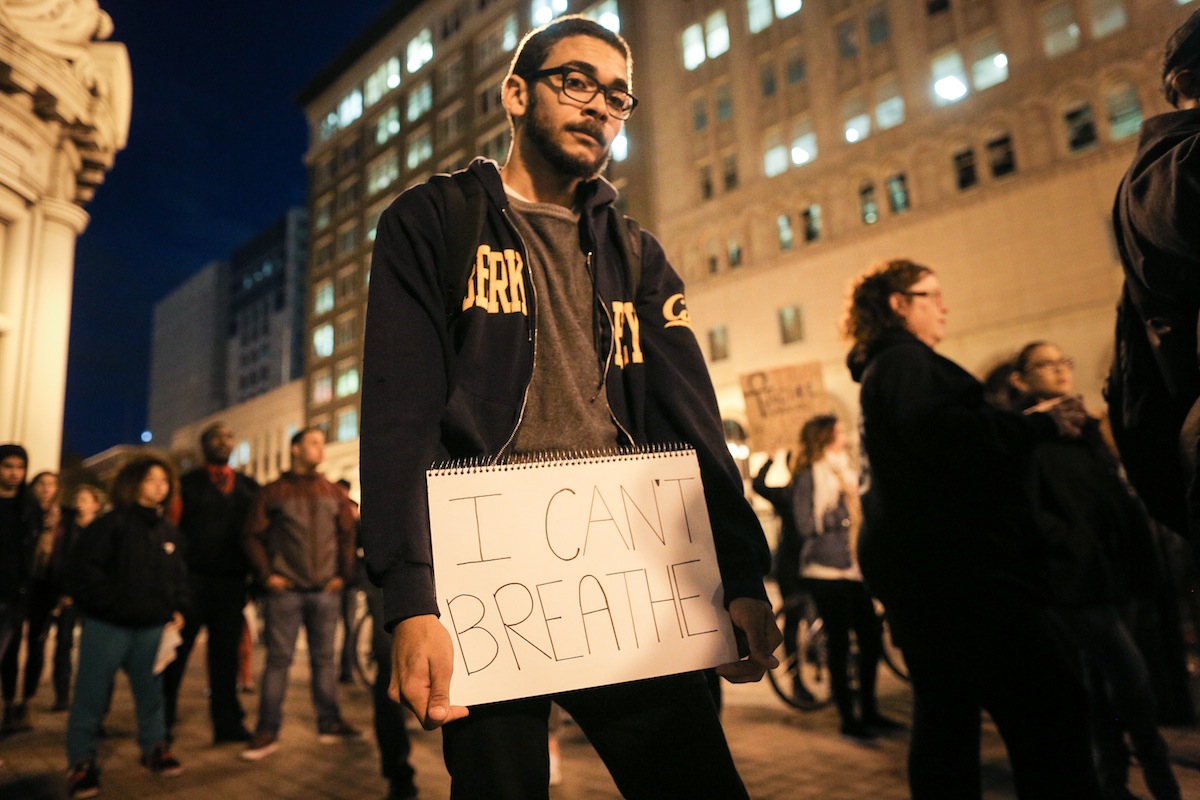 In Oakland, Calif., Niels Smith holds a sign reading "I can't breathe" on the second night of demonstrations following a Staten Island, New York grand jury's decision not to indict a police officer in the chokehold death of Eric Garner, on Dec. 4, 2014. (Elijah Nouvelage—Getty Images)