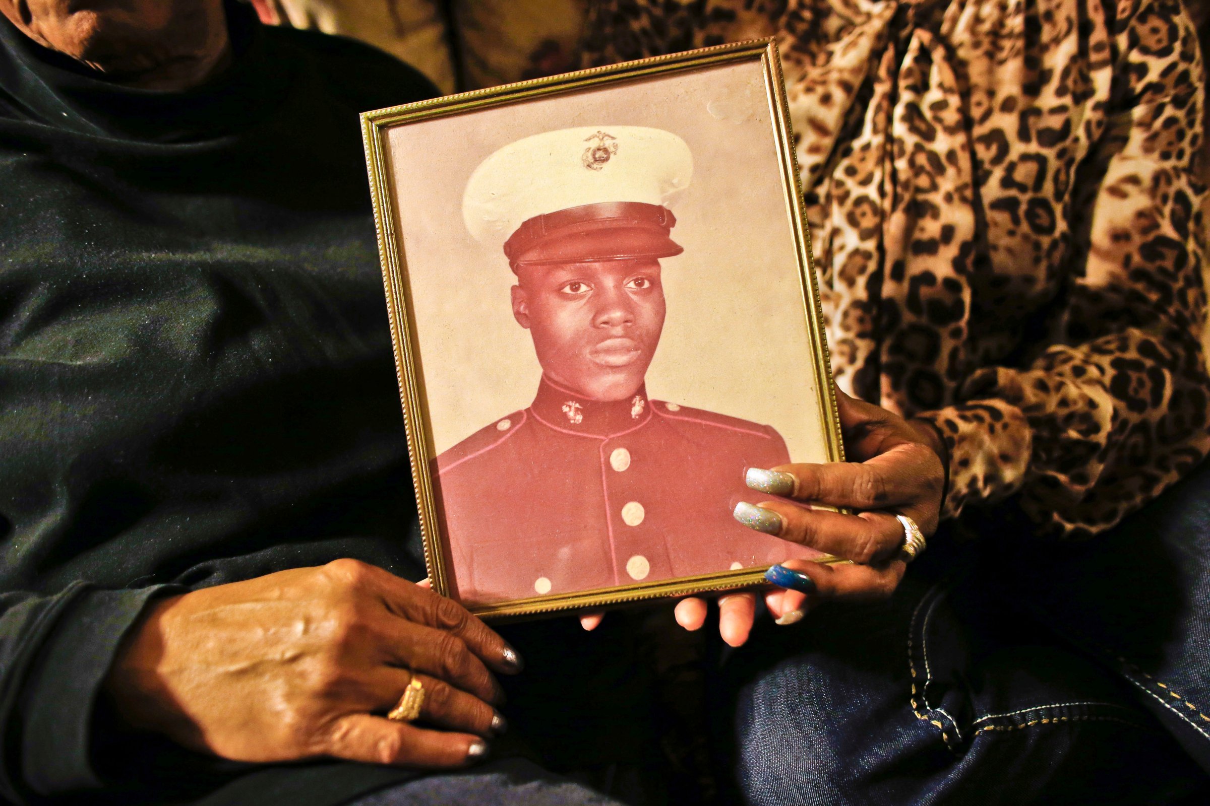 A picture of Jerome Murdough, a former homeless Marine who died in a mental observation unit on Rikers Island jail on Feb. 15, 2014 is held by his mother Alma Murdough left, and sister Cheryl Warner at Alma Murdough's home in the Queens borough of New York.