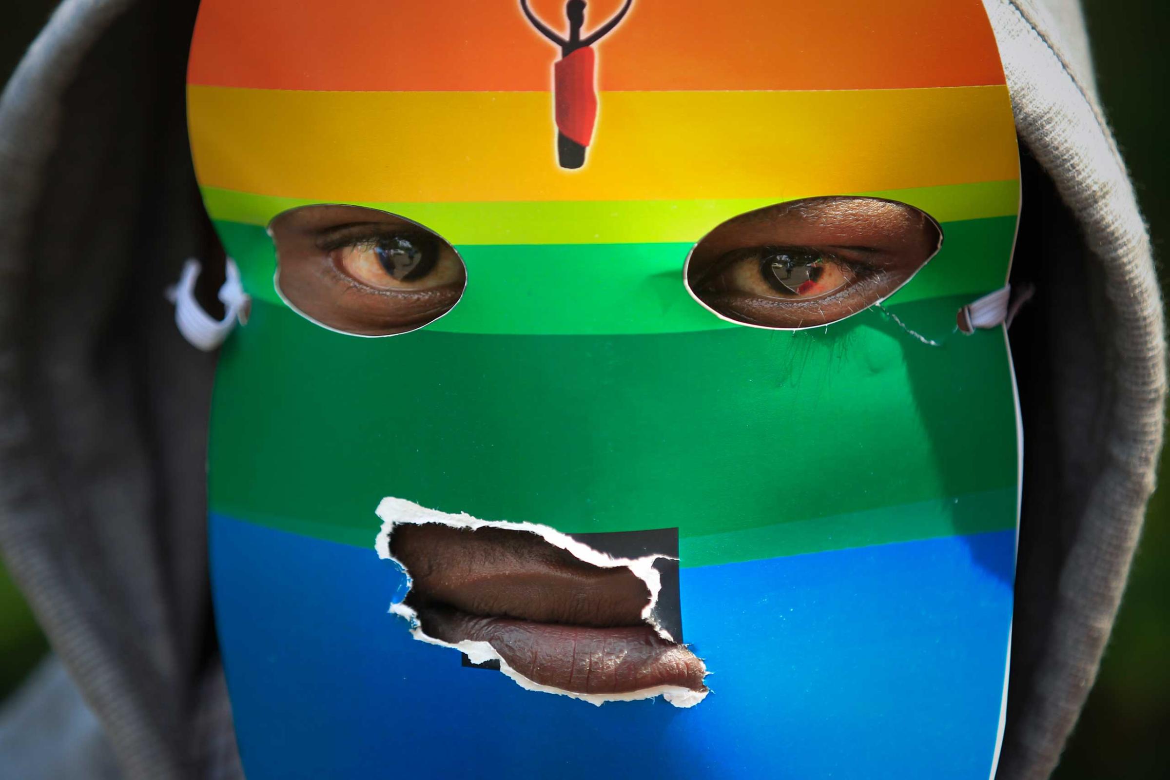 A masked Kenyan supporter of the LGBT community joins others during a protest against Uganda's anti-gay bill in front of the Ugandan High Commission in Nairobi, Kenya, Feb. 10, 2014.