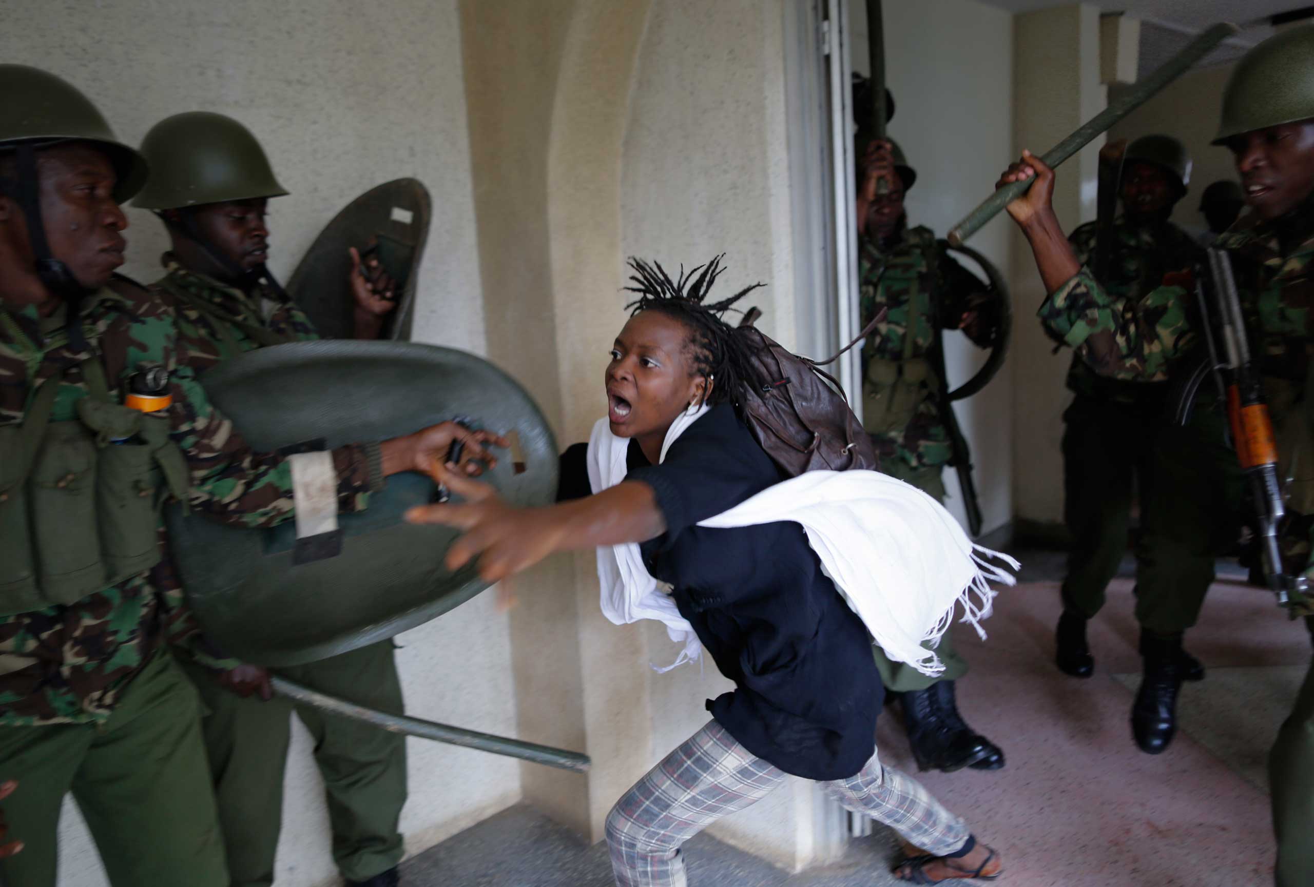 European Pressphoto Agency: Best Photos of 2014A woman flees as a riot police officer beats her with a baton, after chasing protesting students into the Nairobi University campus in Nairobi, Kenya, May 20, 2014. The students were demonstrating against proposed tuition fee hikes.