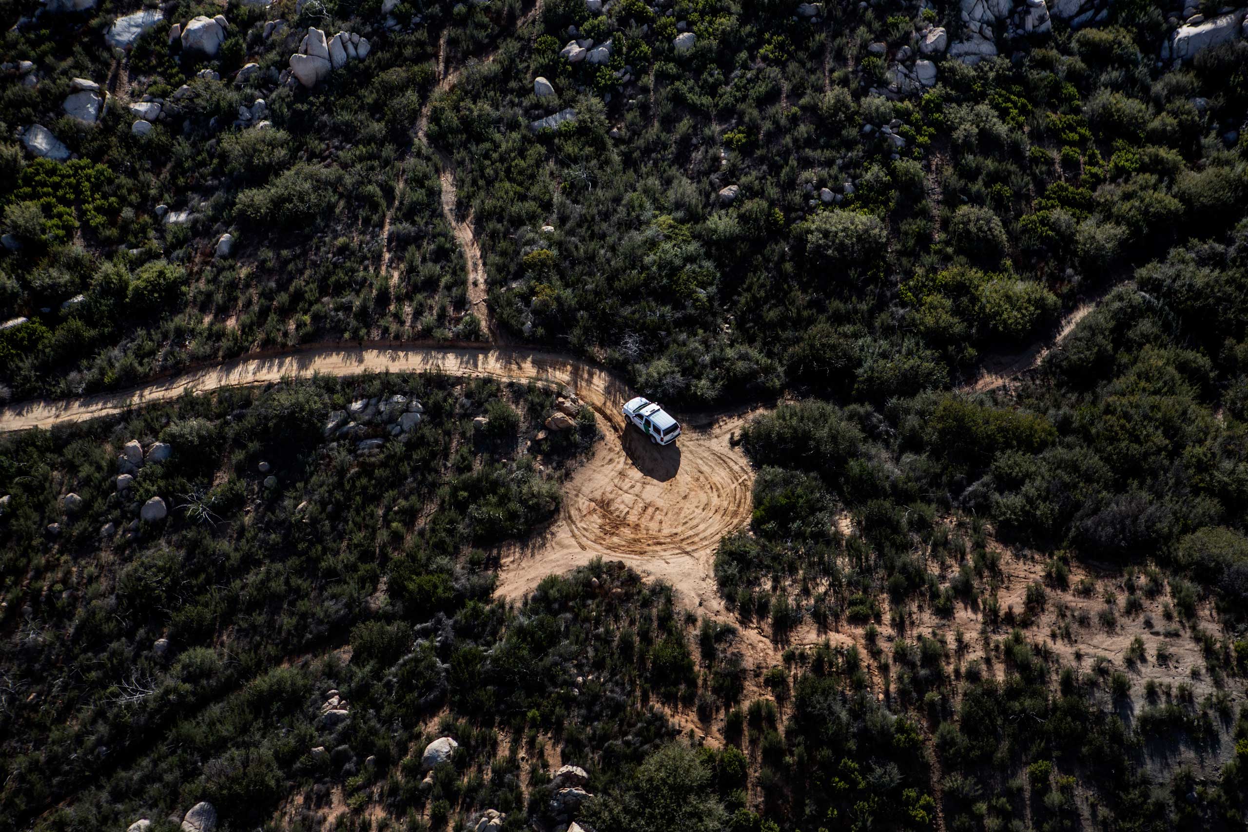 A border patrol vehicle on the remote terrain along the border in Southern California, east of San Diego, Feb. 15, 2013.