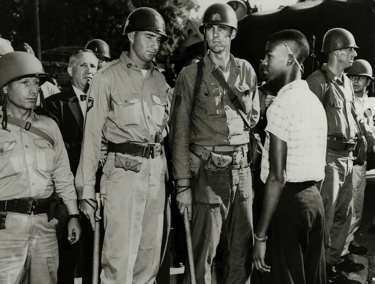 Little Rock, Ark., 1957: National Guardsmen, having admitted white children to a school, bar the way to a black student (Paul Popper—Popperfoto / Getty Images)