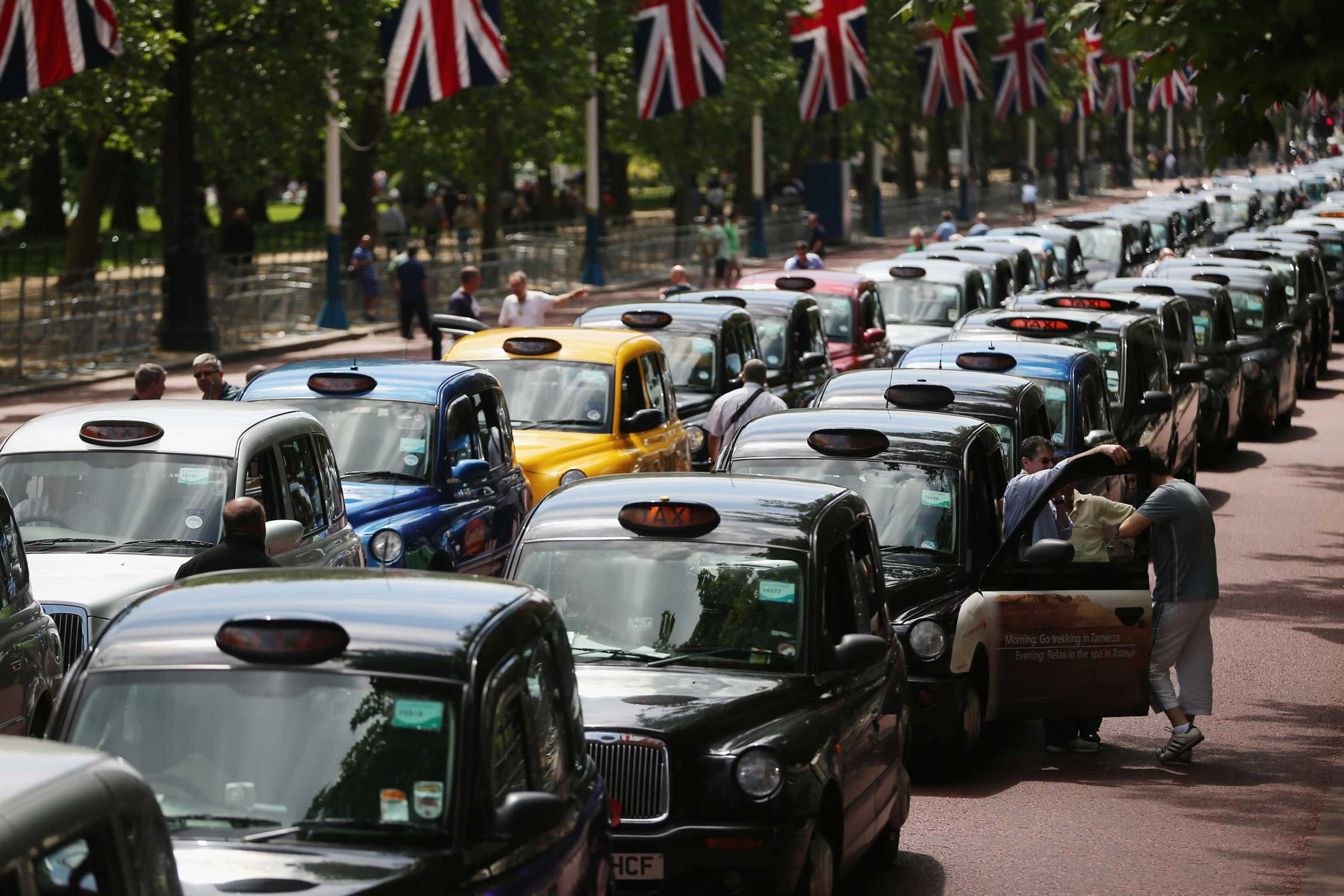 London taxi's line up on The Mall during a protest against a new smart phone app, 'Uber' on June 11, 2014 in London.