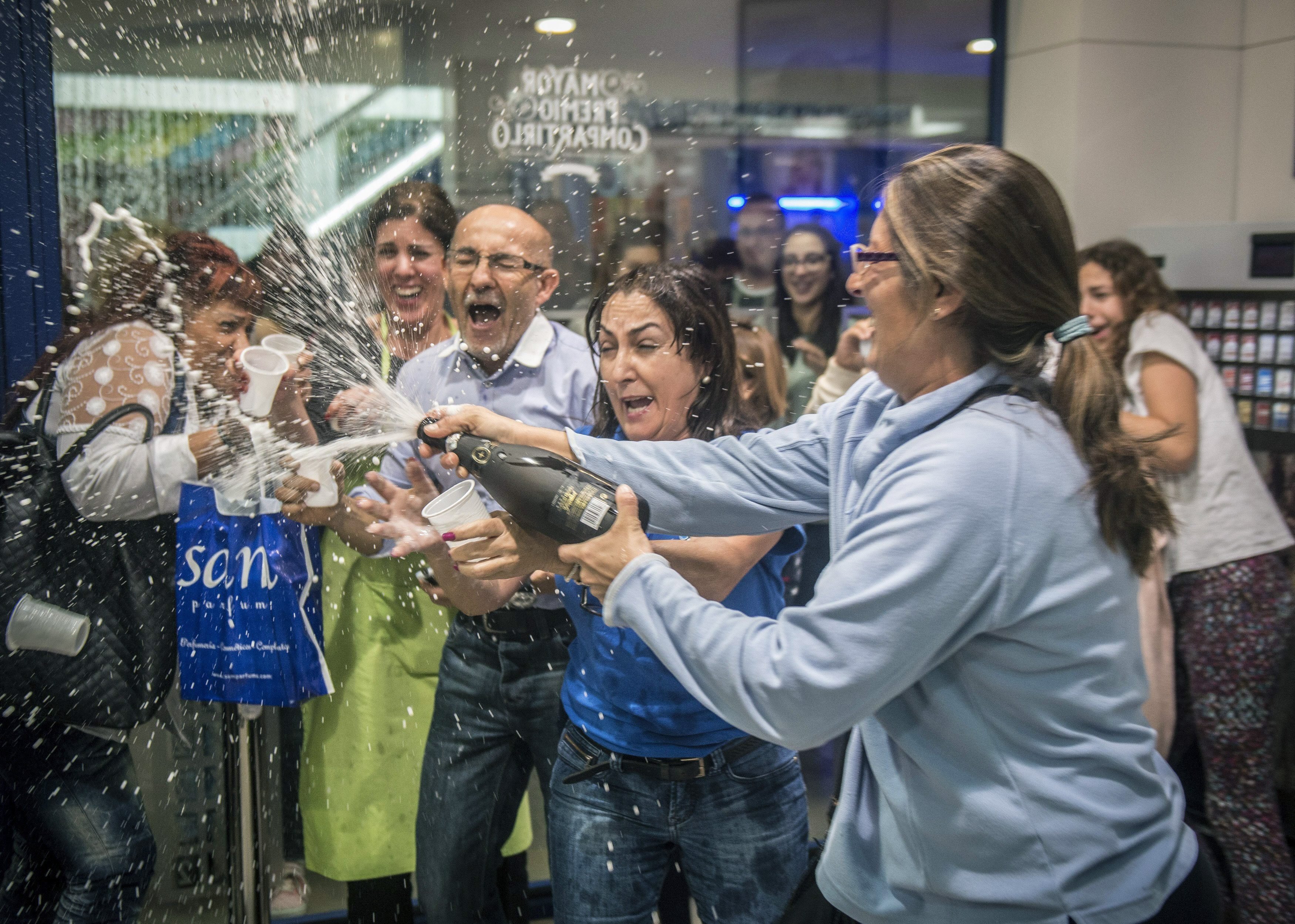 The owner of a lottery administration at the Deiland-Chimida mall in Lanzarote, Canary Islands, Spain, celebrates selling the number 13,437 ticket that was awarded with the first prize of the traditional Spanisch Christmas Lottery 'El Gordo', on Dec. 22, 2014. (Javier Fuentes—EPA)