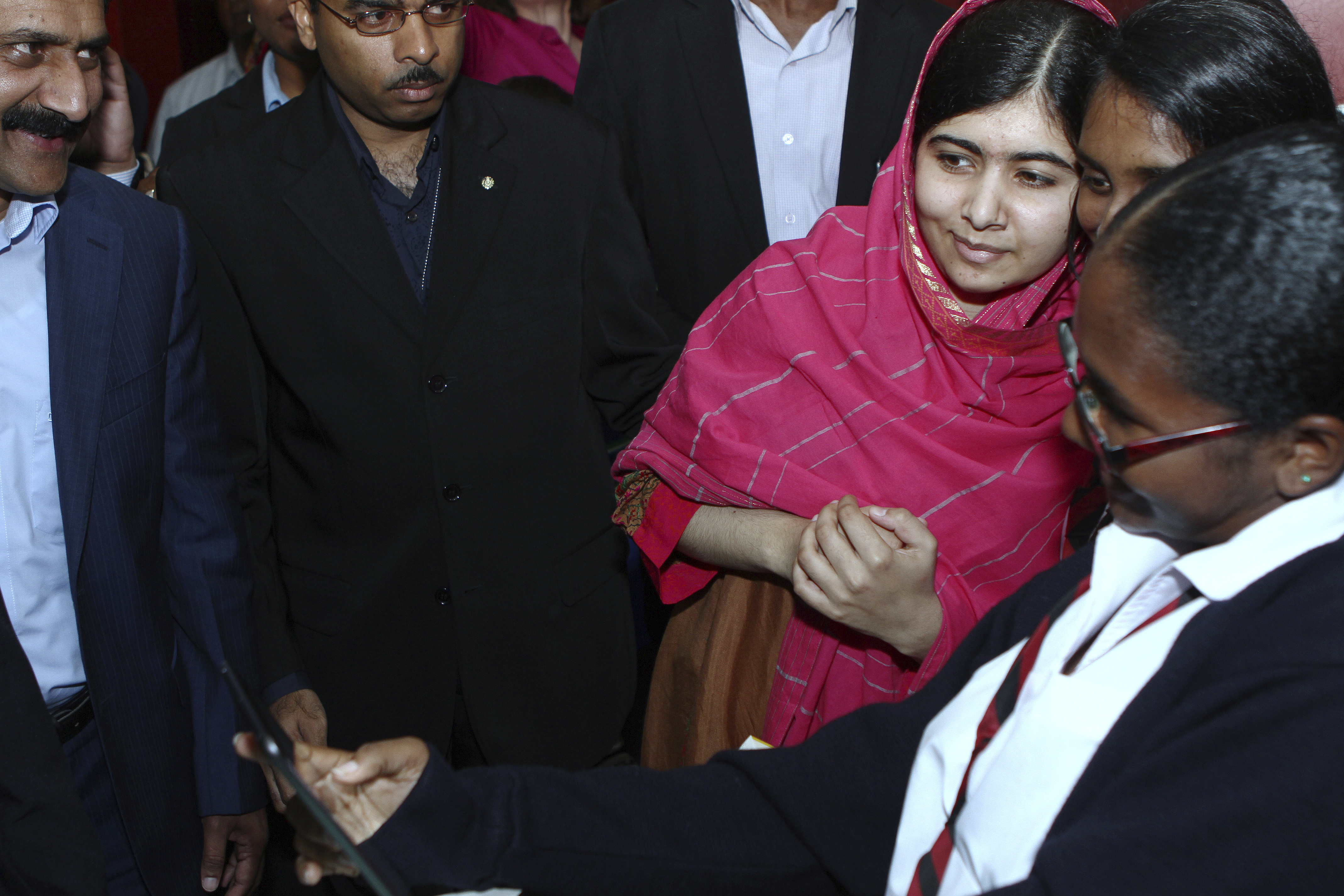 Malala Yousafzai poses for a selfie with admirers at the National Academy for the Performing Arts on July 30, 2014 in Port of Spain, Trinidad. (Sean Drakes/CON&mdash;LatinContent/Getty Images)