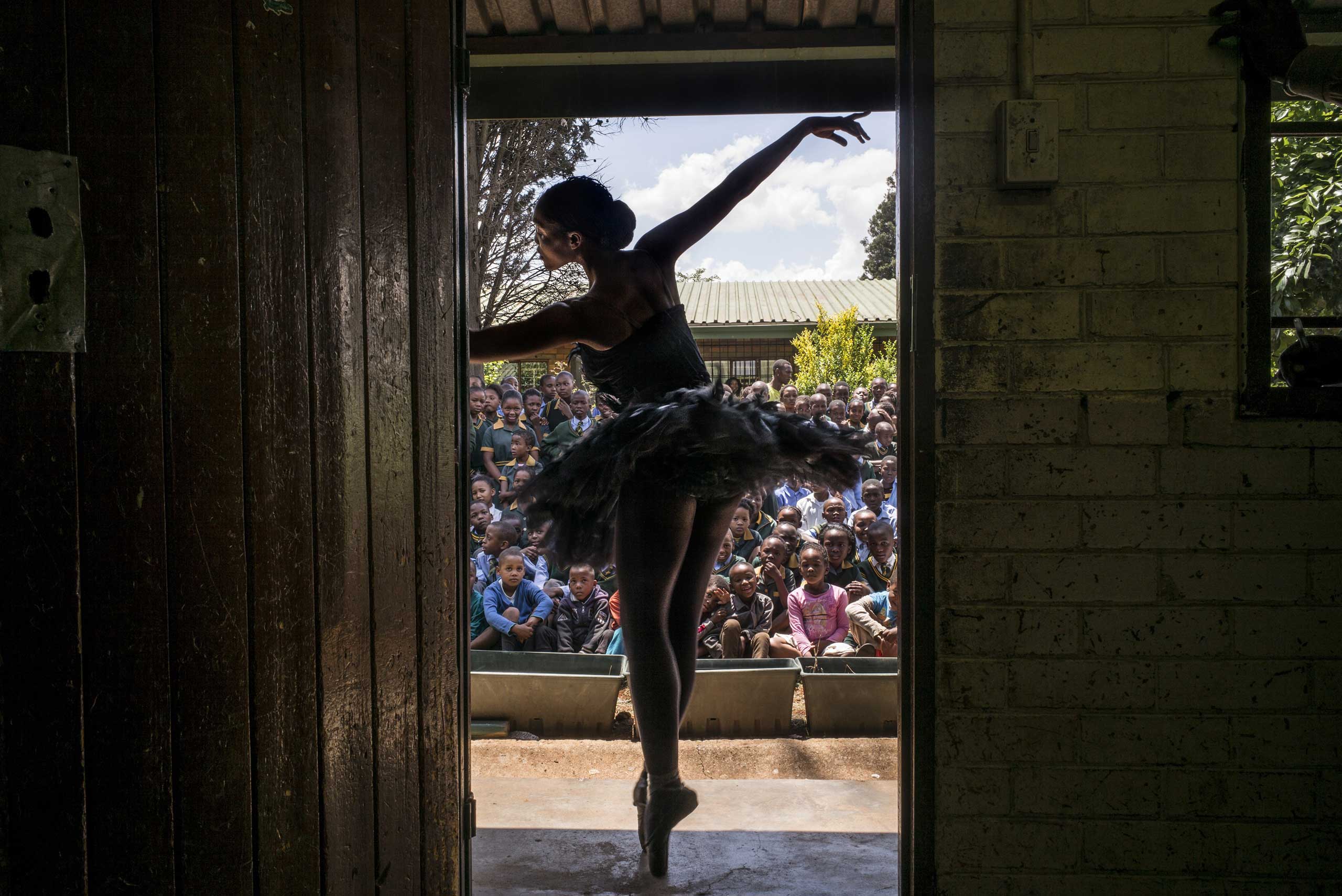 The Wall Street Journal: Photos of the Year 2014Senior soloist of the Joburg Ballet Kitty Phetla performs in a classroom at the Nka-Thuto Primary School in Soweto on Oct. 16, 2014.