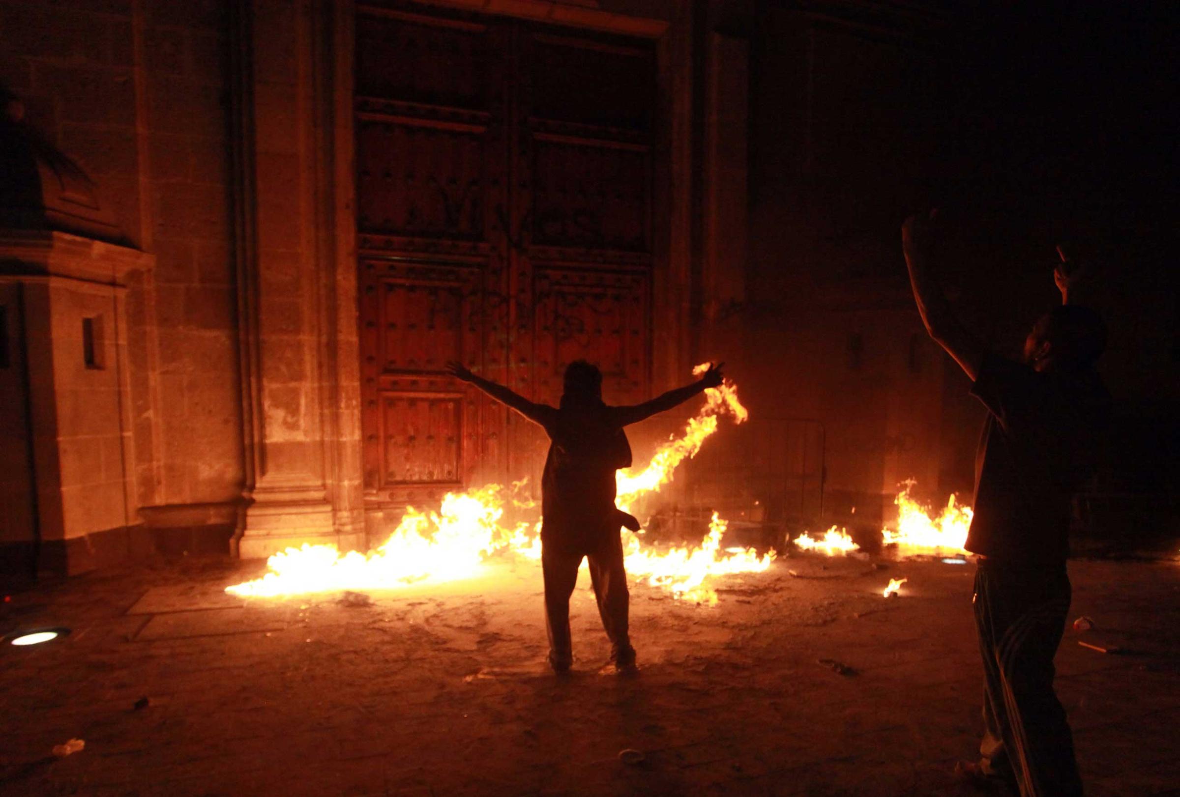 Demonstrators set on fire a door of the National Palace in Mexico City, Nov. 8, 2014.