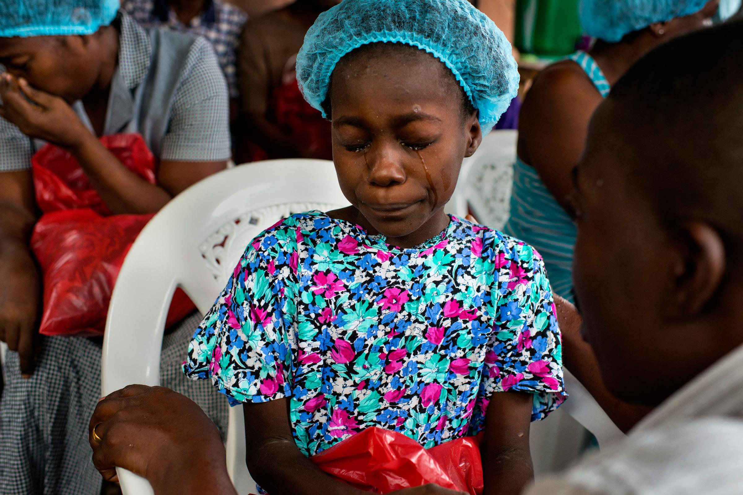 Esther Tokpah, 11 an orphan, weeps as Dr. Jerry Brown tries to console her before she was released from care on Sept. 24, 2014 in Monrovia, Liberia.