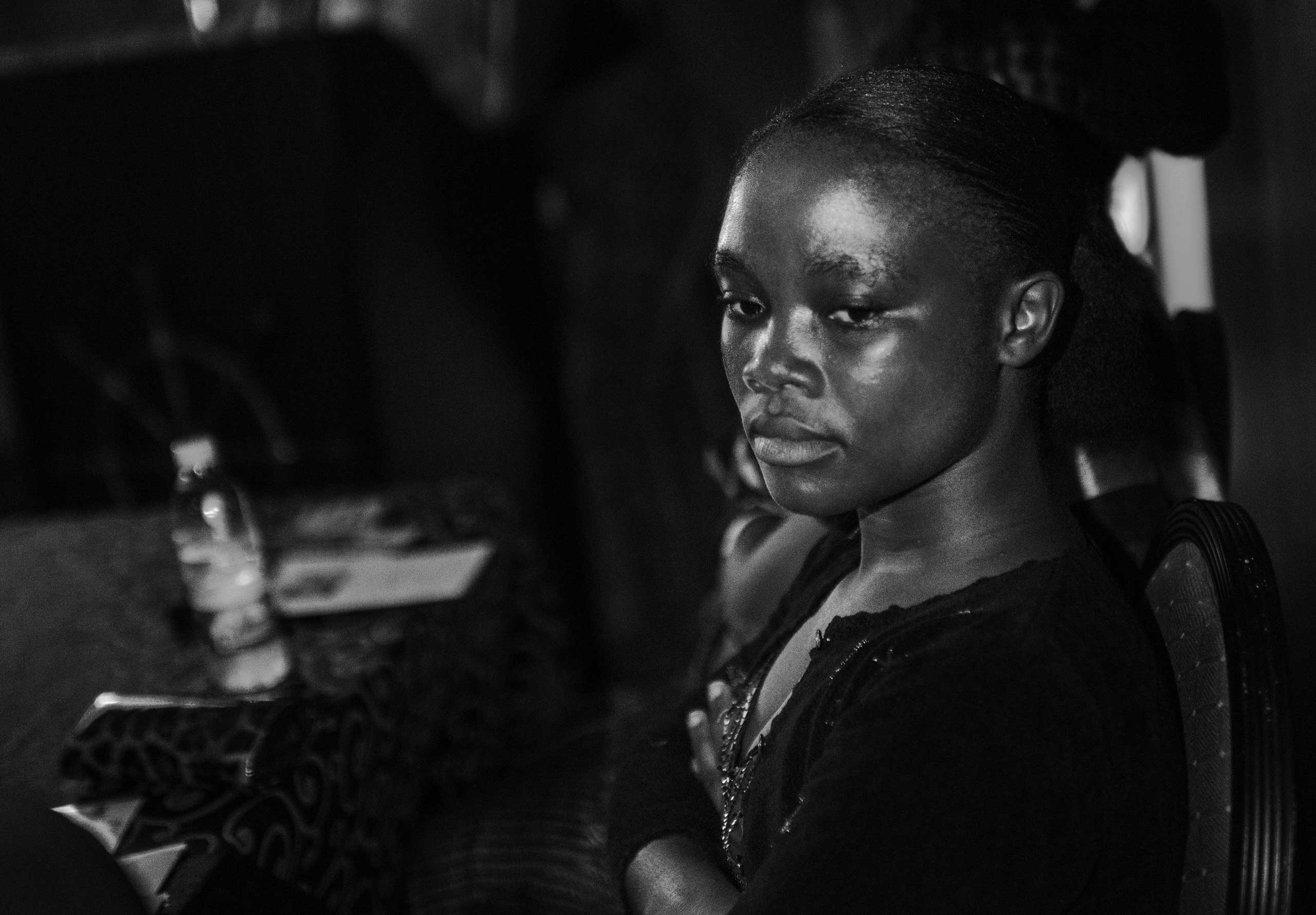 Decontee Davis, an Ebola survivor, spends a moment alone pondering during a music video launch party to raise awareness on Ebola, Nov. 12, 2014 in Monrovia, Liberia.
