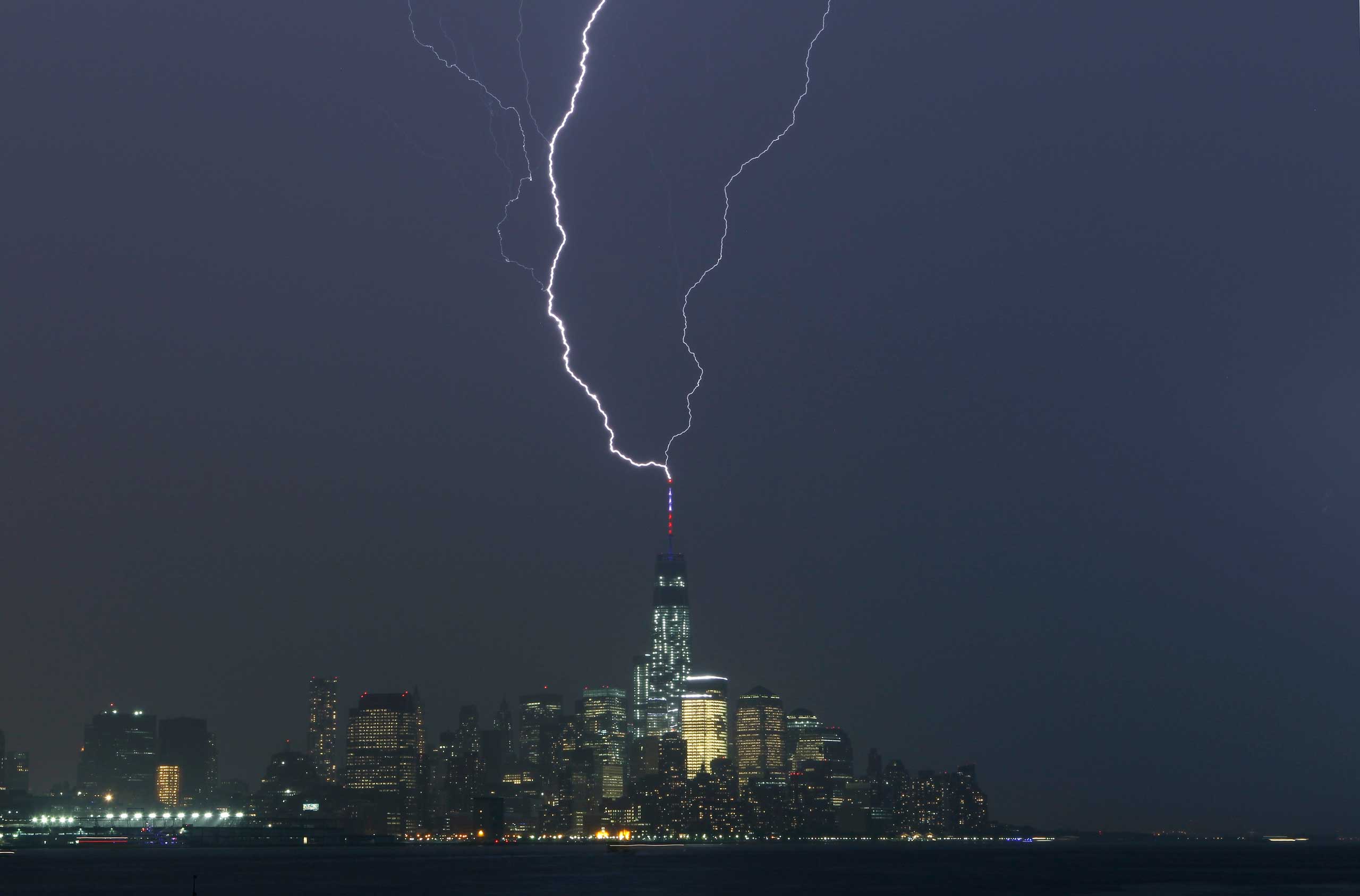 Two bolts of lightning hit the antenna on top of One World Trade Center in Lower Manhattan as an electrical storm moves over New York, May 23, 2014.