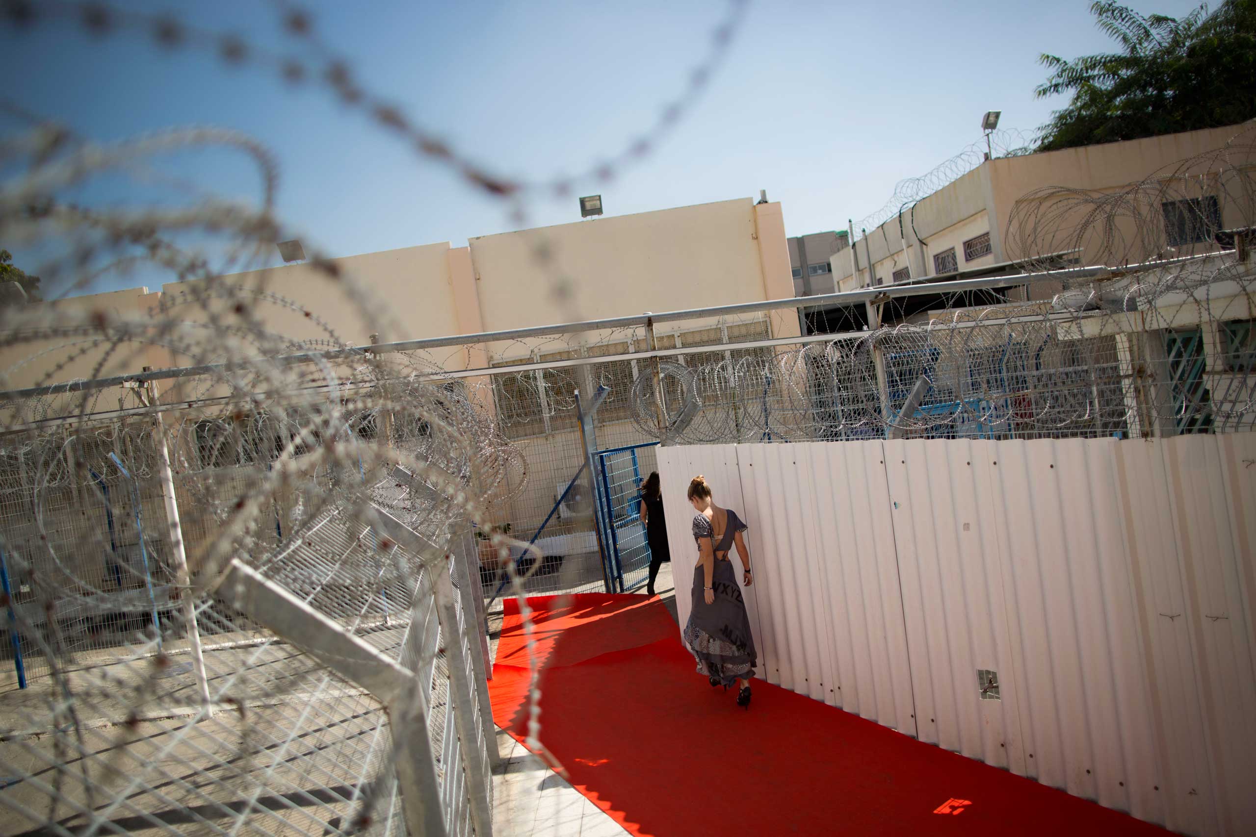 A model prepares to walk a runway before a fashion show in Neve Tirza prison, Israel's only women prison in Ramle, central Israel, Oct. 27, 2014.