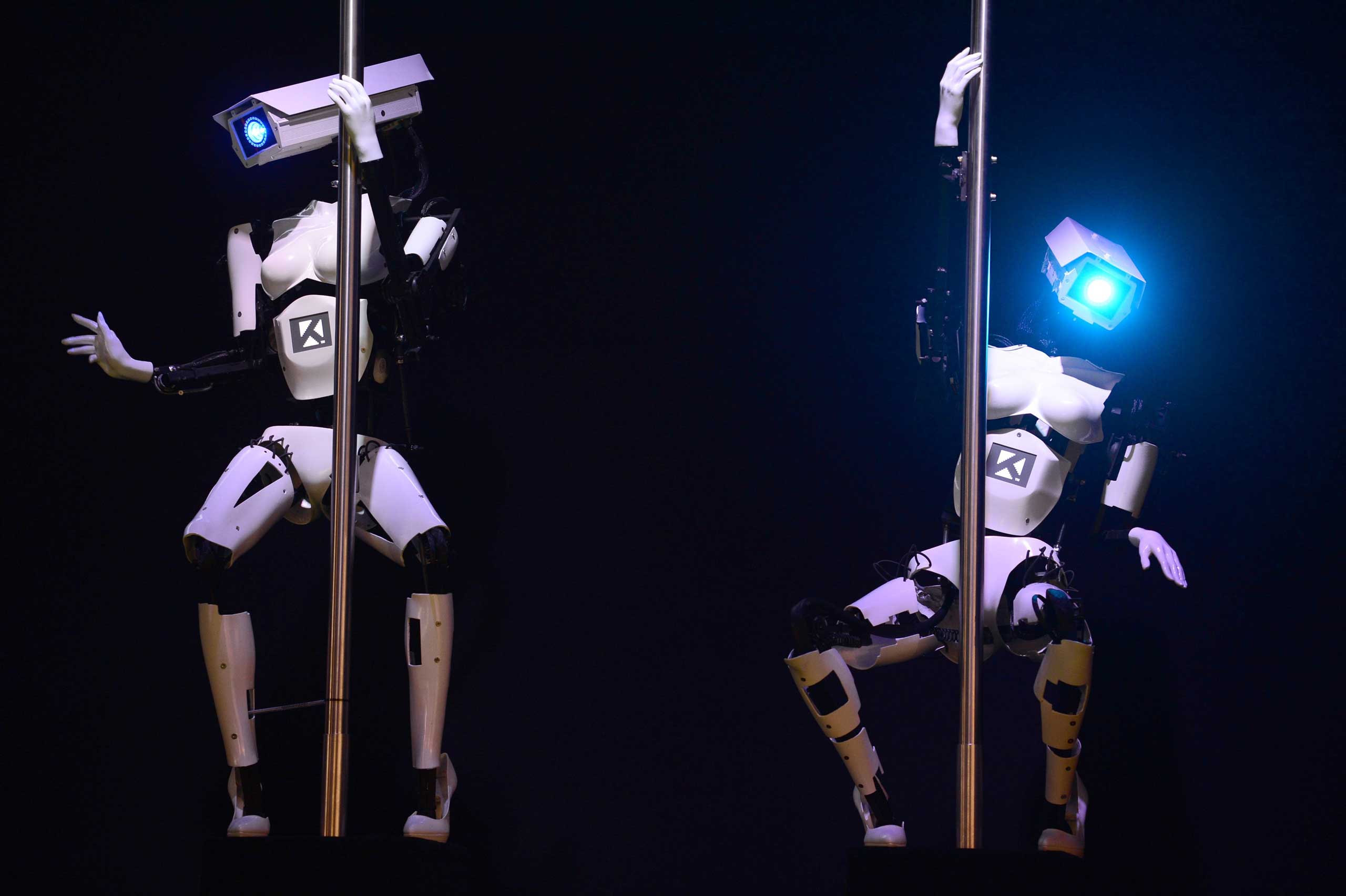 Robots perform a pole dance at a technology show booth occupied by the Tobit Software company, Germany March 9, 2014.