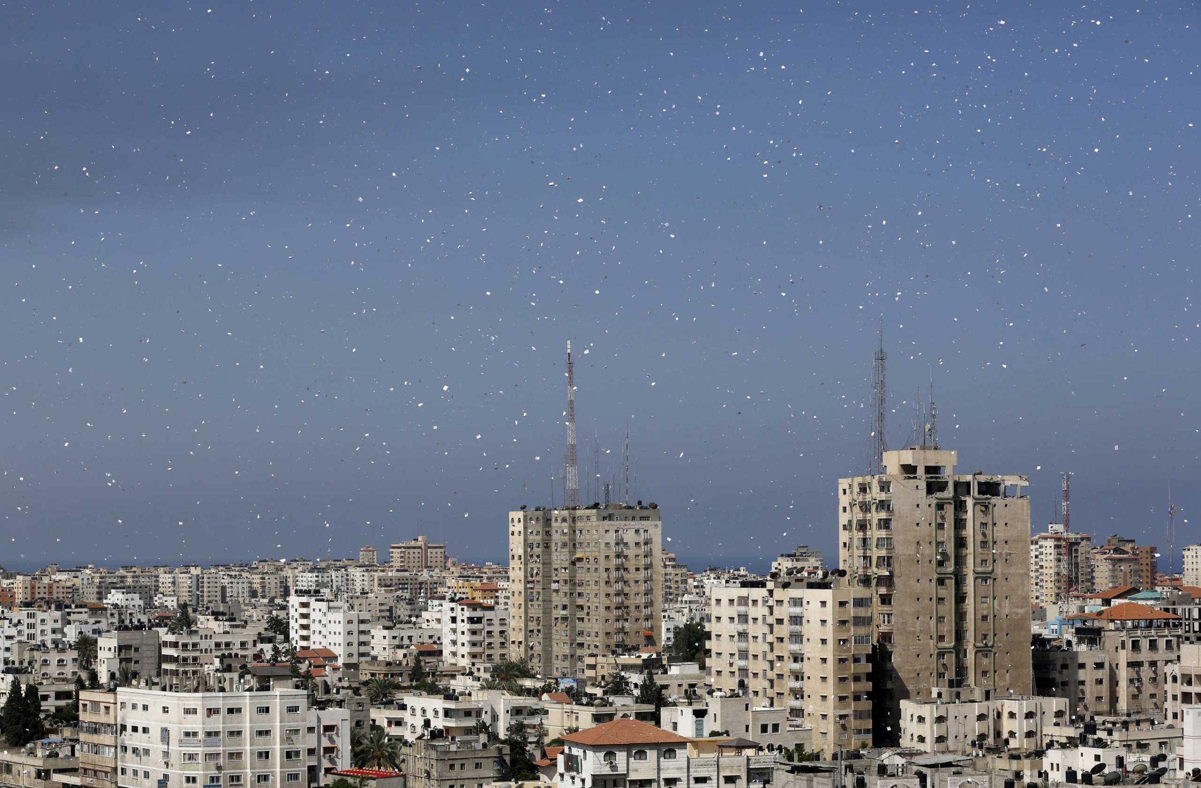 Flyers are dropped over Gaza City by the Israeli army urging residents to evacuate their homes, July 30, 2014.