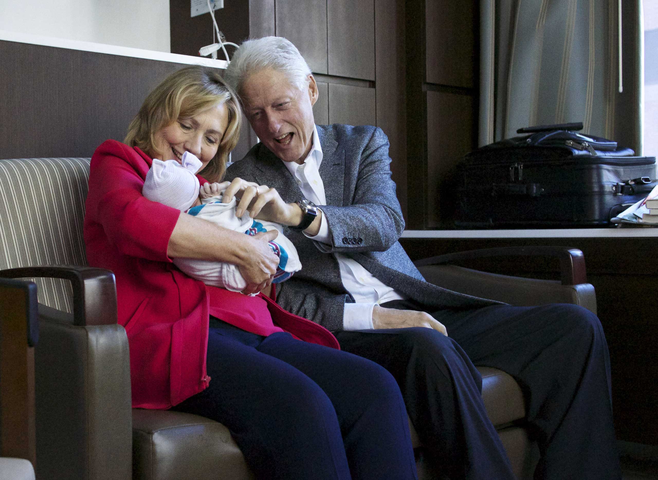 Bill and Hillary Clinton cuddle their
                              first grandchild, Charlotte Clinton Mezvinsky,
                              at a New York City hospital on Sept. 27, 2014.