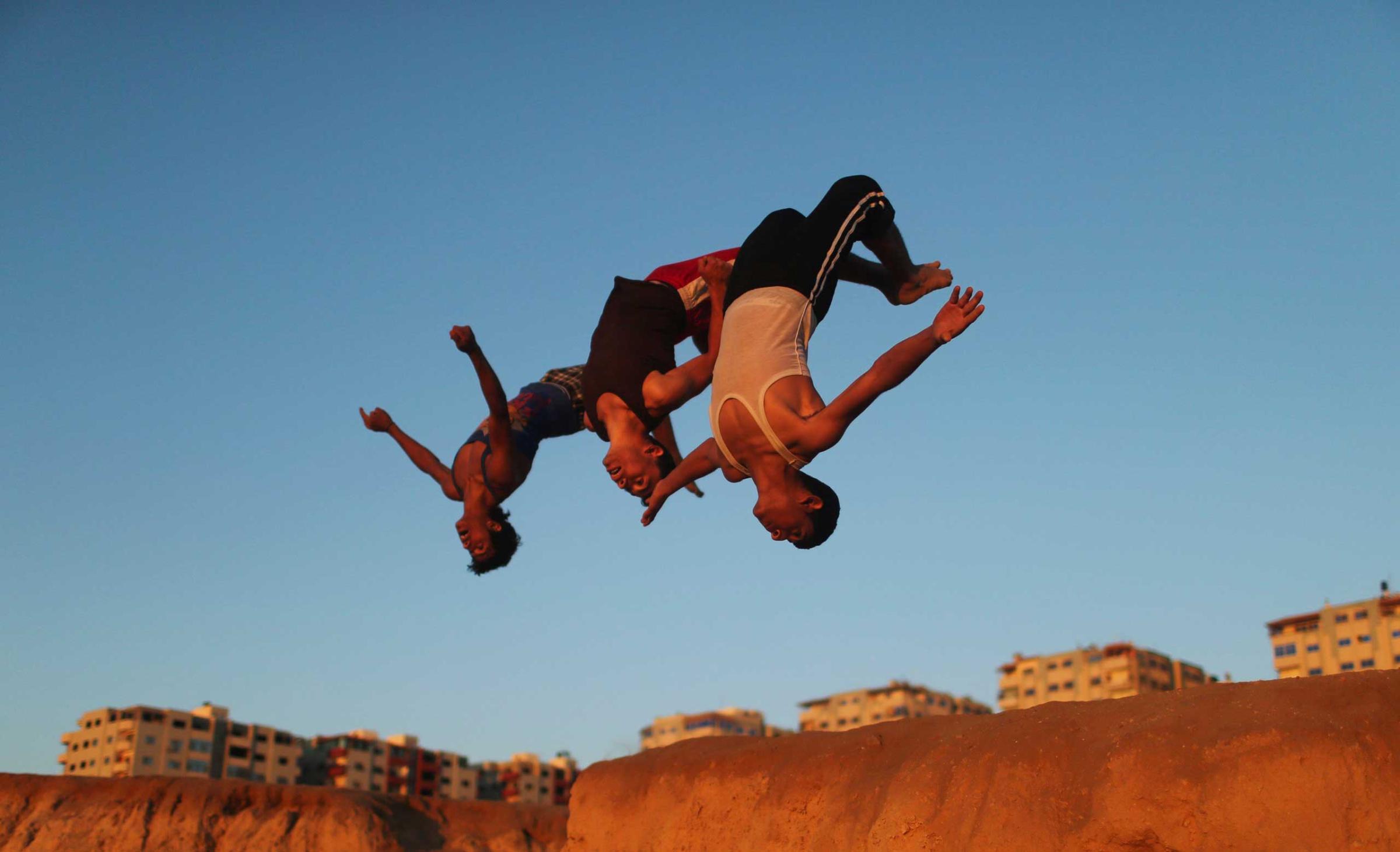 Palestinian youths practice their parkour skills at the Shati refugee camp in Gaza City
