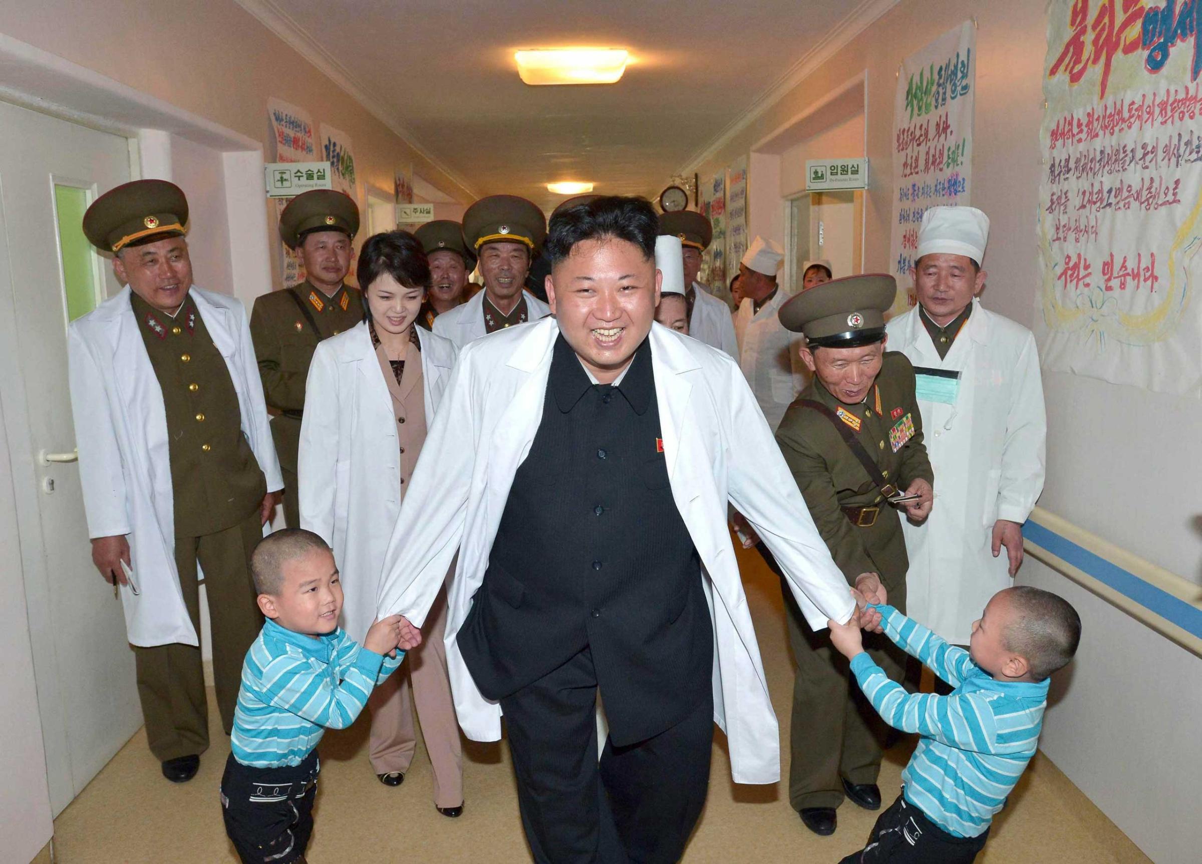 North Korean leader Kim Jong un plays with children during a visit to the Taesongsan General Hospital in this undated photo released by North Korea's KCNA agency in Pyongyang