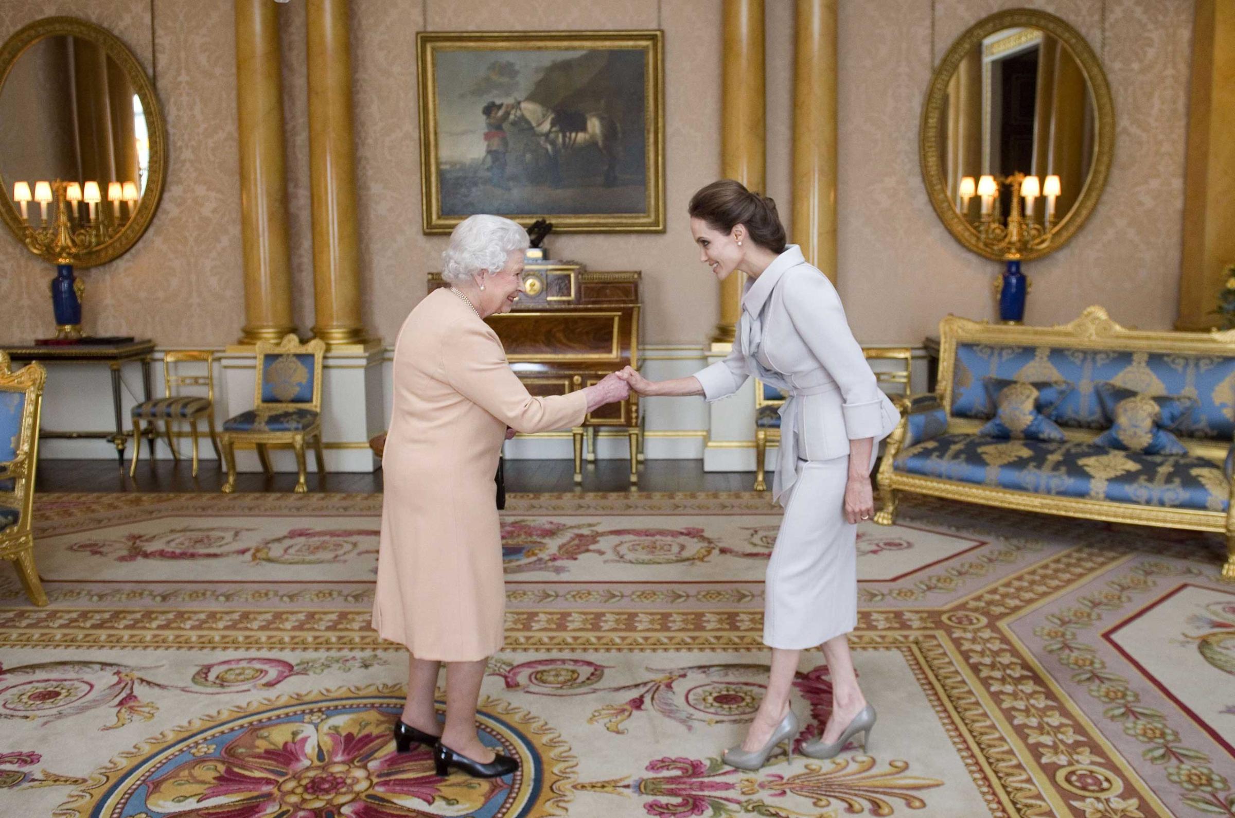 Angelina Jolie, actor and humanitarian, is presented with honorary damehood by Britain’s Queen Elizabeth II in London on Oct. 10 for her services to U.K. foreign policy and her campaign to end sexual violence in war zones.