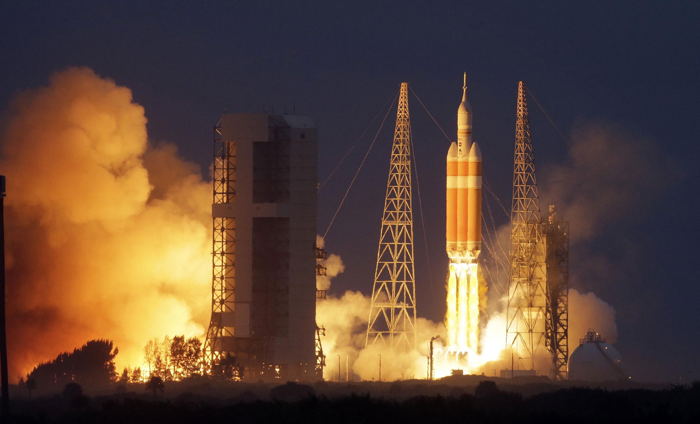 NASA's Orion spacecraft, atop a United Launch Alliance Delta 4-Heavy rocket, lifts off on its first unmanned orbital test flight from the Cape Canaveral Air Force Station on Dec. 5, 2014, in Cape Canaveral, Fla.